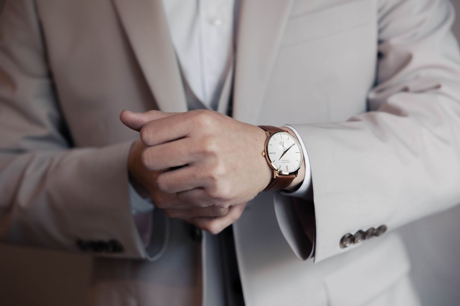 Multiple angles of someone checking their watch while wearing formal attire.