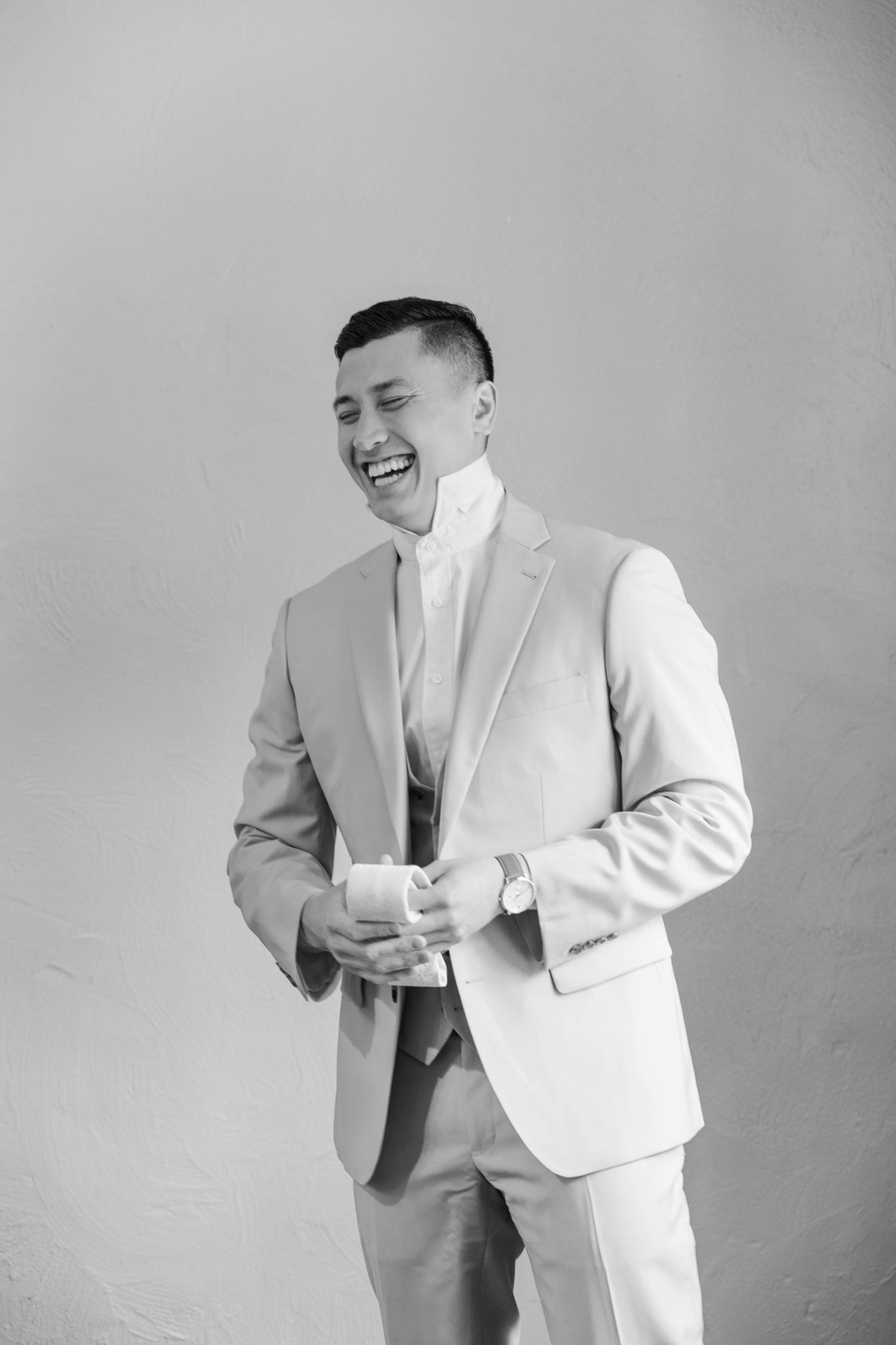 Candid sequence showing joyful moments in formal attire against a grey background.