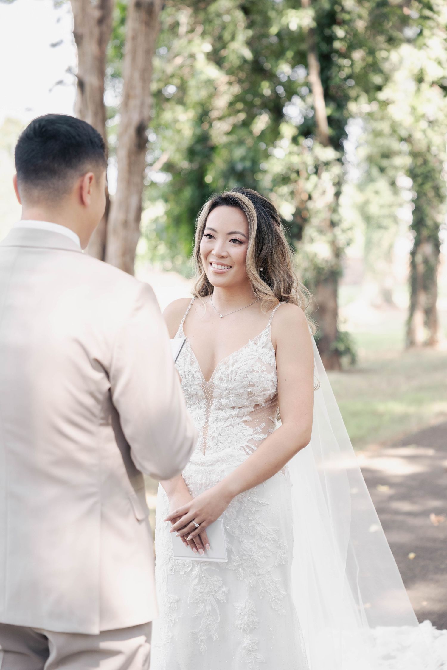 A couple shares an intimate moment during their forest wedding photoshoot.