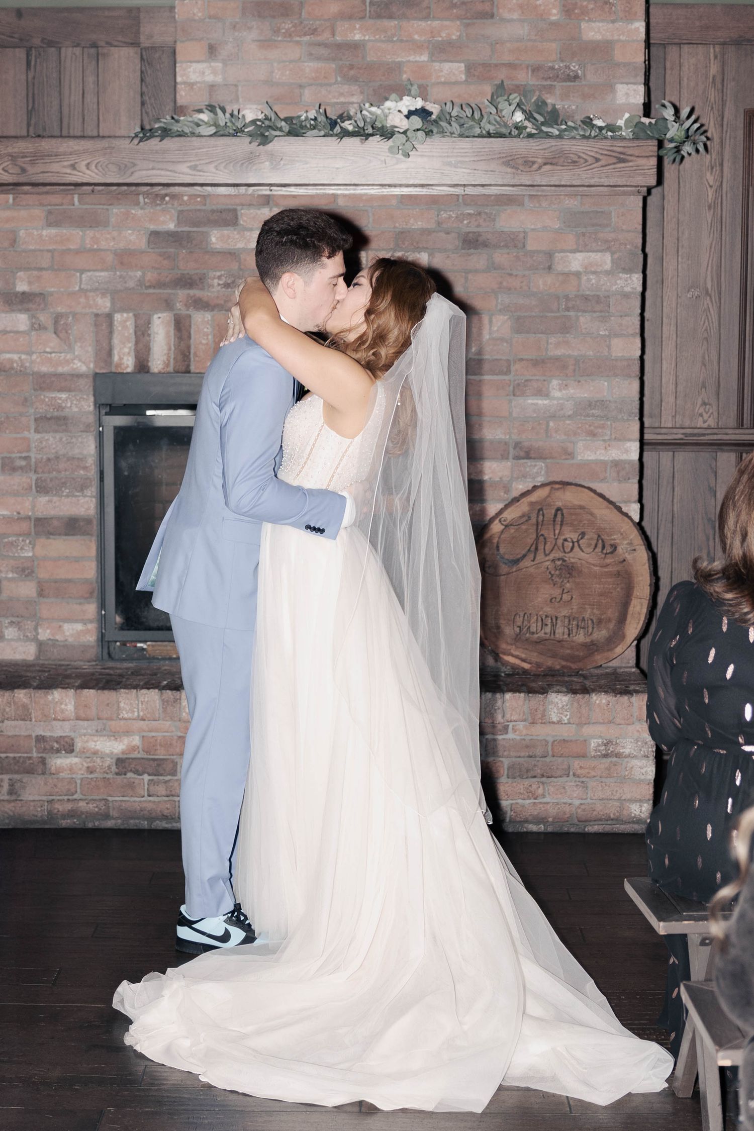 A romantic first dance sequence showing the newlyweds spinning and twirling on a dance floor with exposed brick walls.