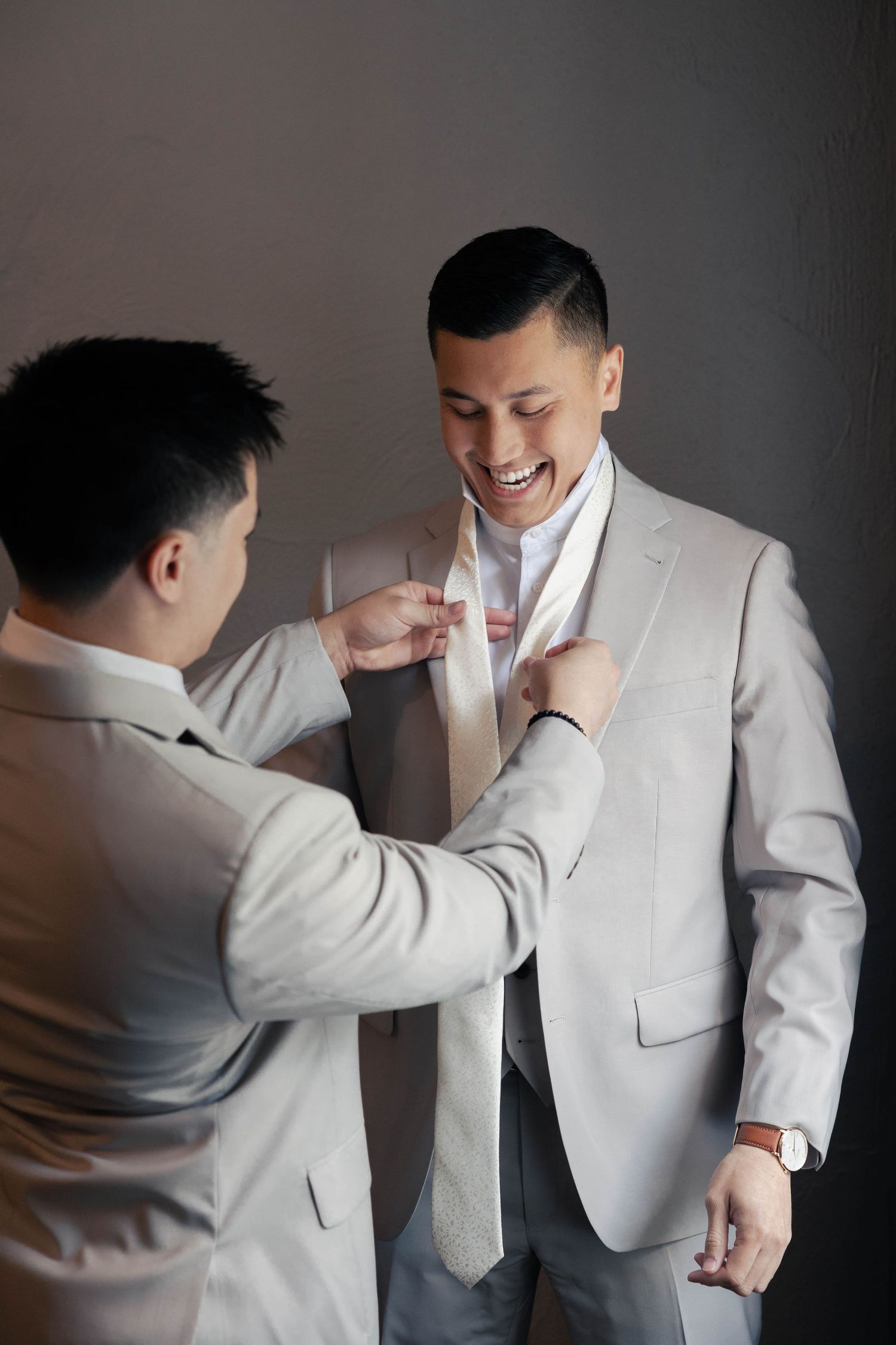 Series of shots showing formal attire adjustments in natural lighting.