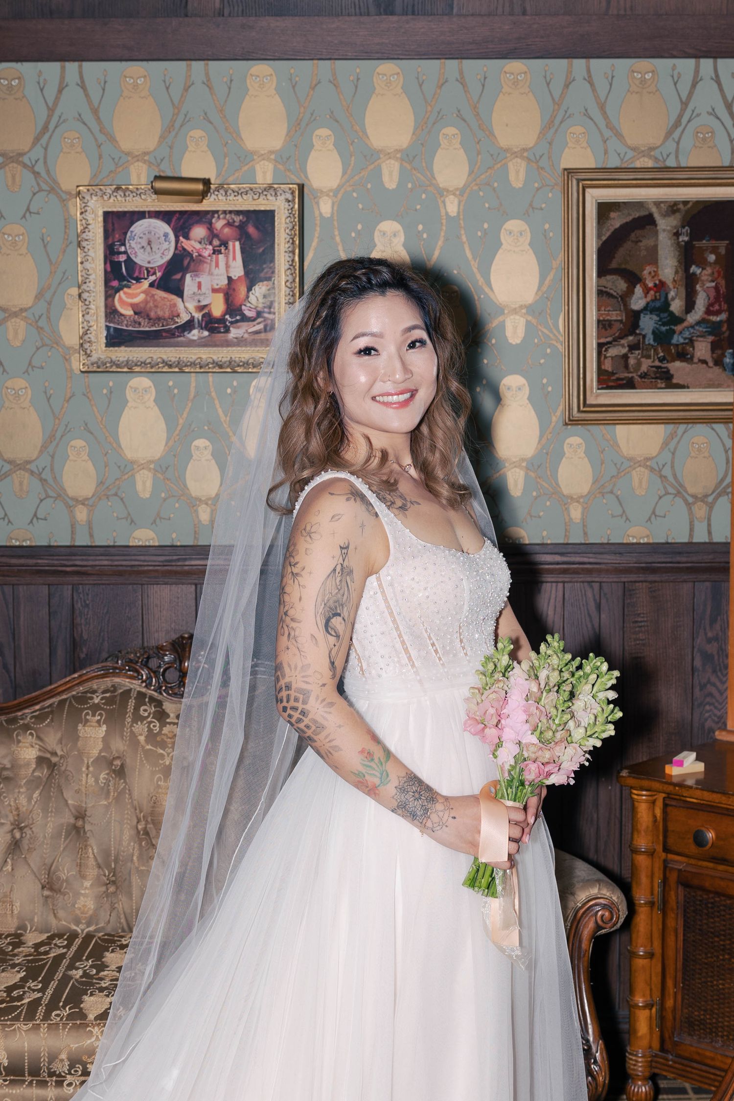 Wedding portraits in an elegant vintage room with patterned wallpaper and wooden details.