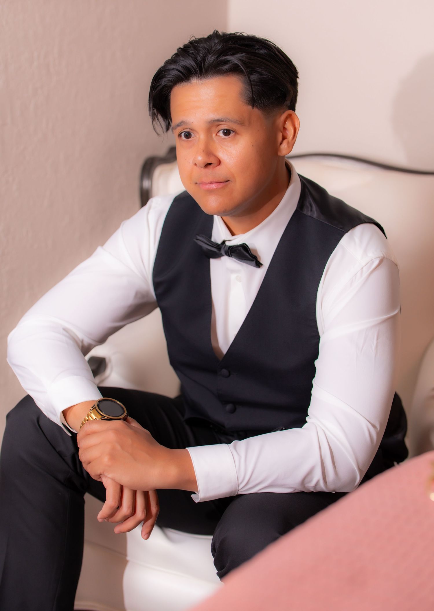 Professional portrait series showing a person in formal attire posing on a pink couch against a neutral background.