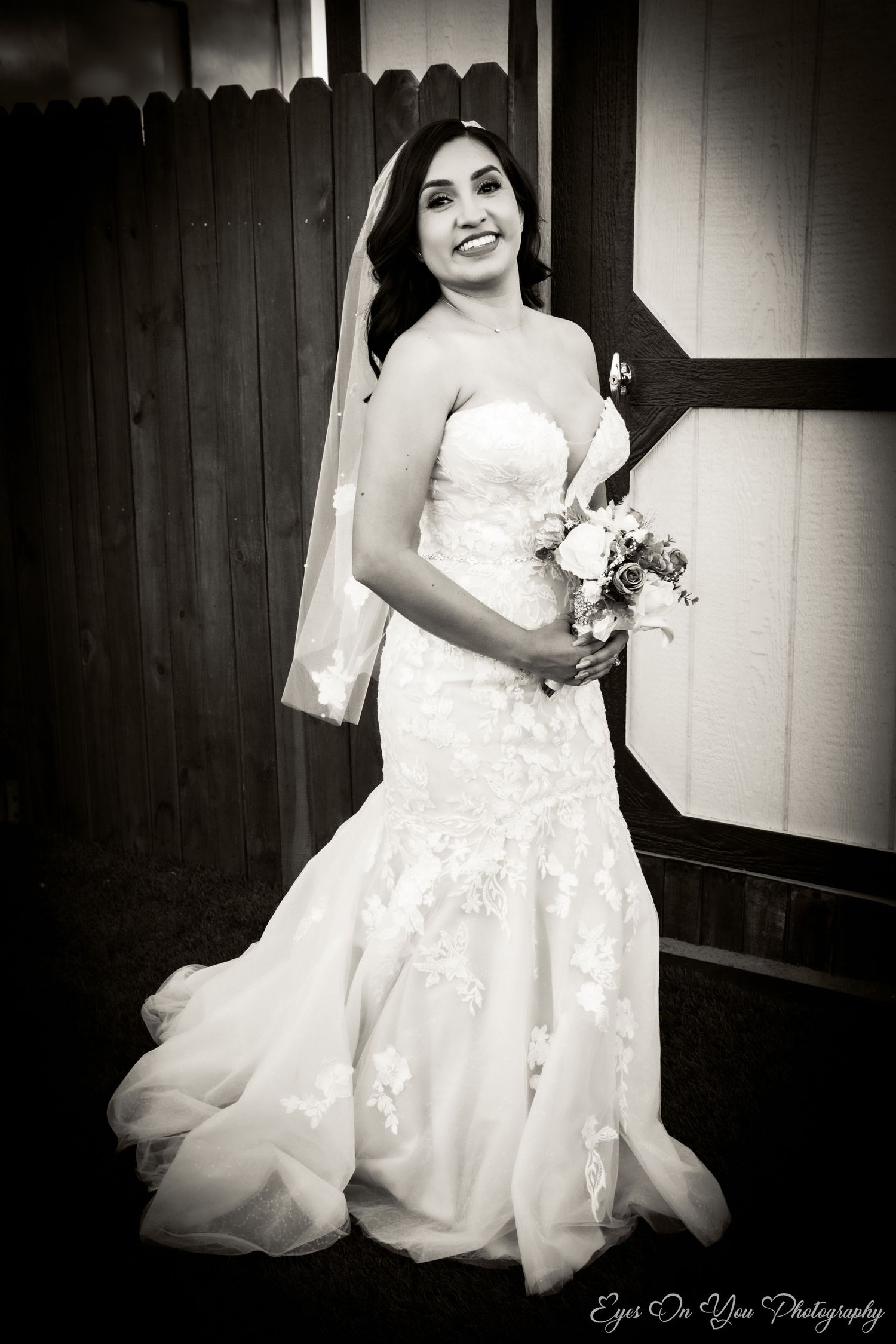 Black and white wedding photography featuring bride in lace gown.