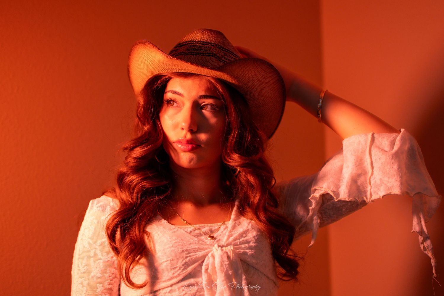 Cinematic sequence with dramatic red lighting and cowboy hat.