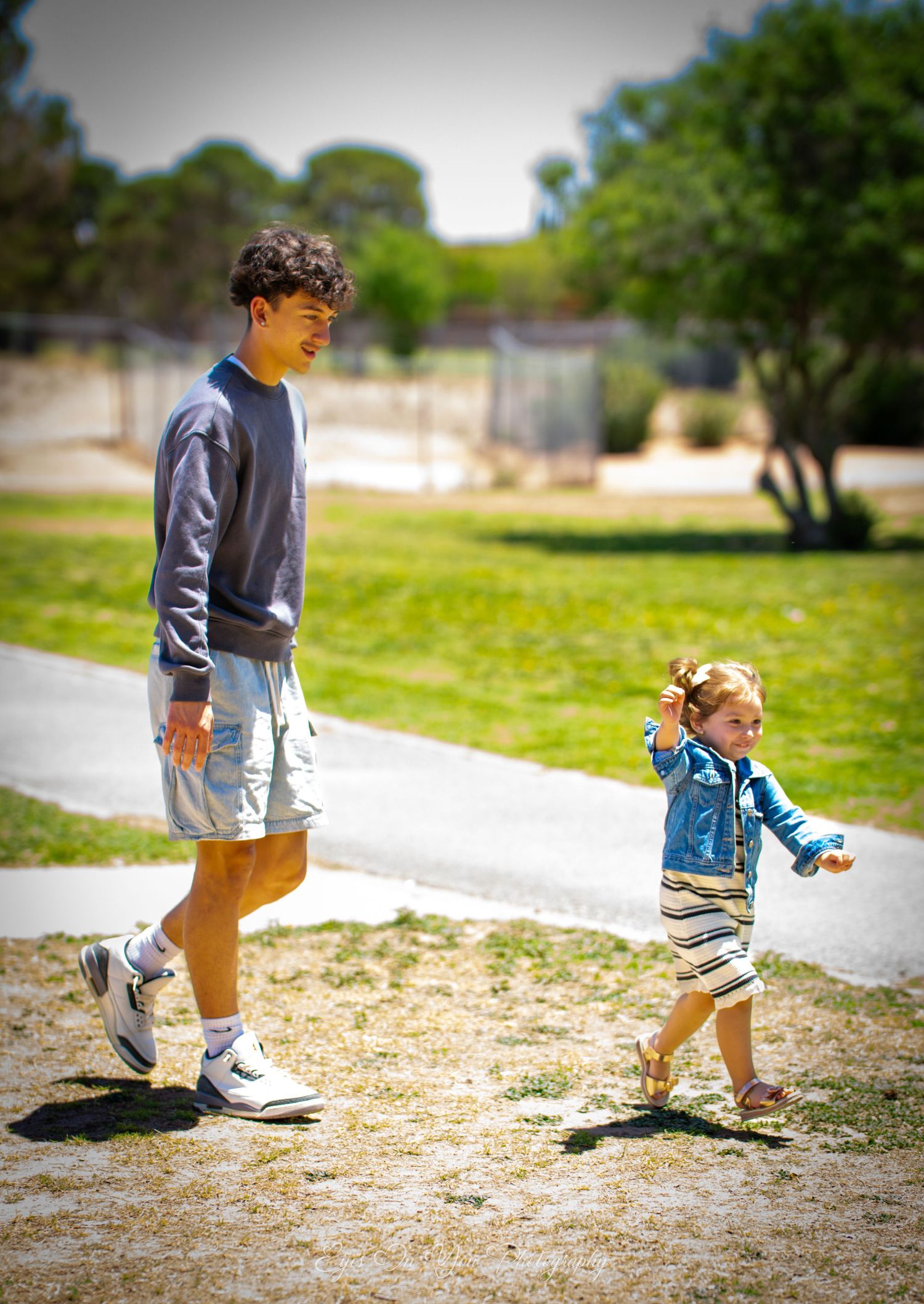 Series of shots showing a young child walking on a path outdoors.