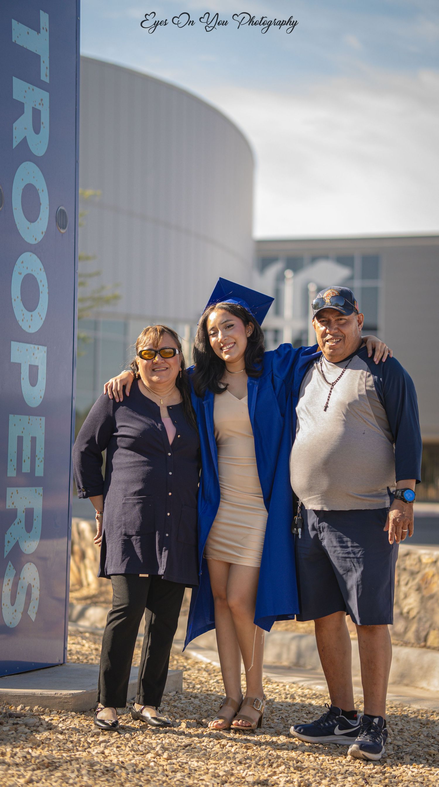 Group photo session outside Eastwood High School with graduates and family members.