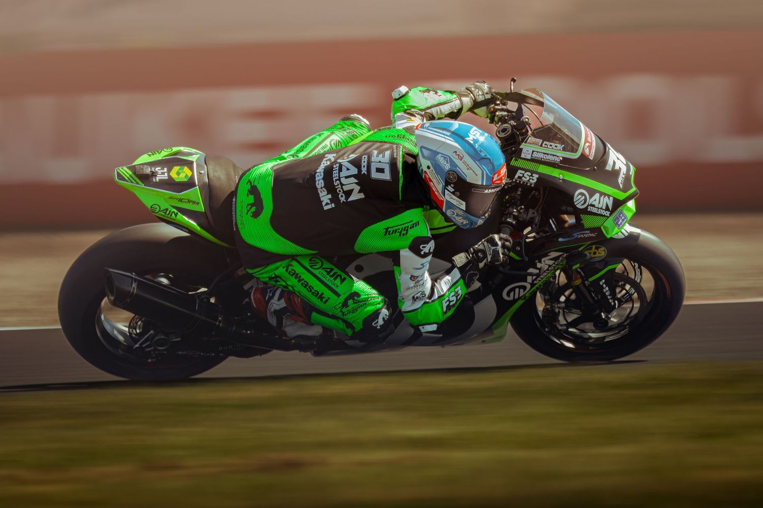 Max Cook power through a corner at Donington Park Race circuit  during sunset.
