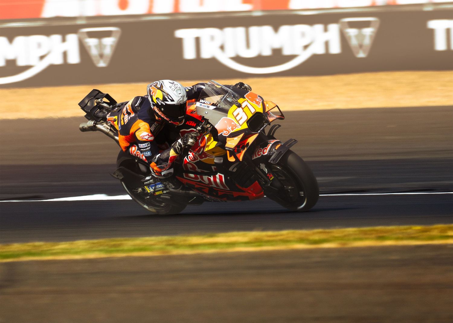 Pedro Acosta leans into a high-speed turn on a race track during British MotoGP.