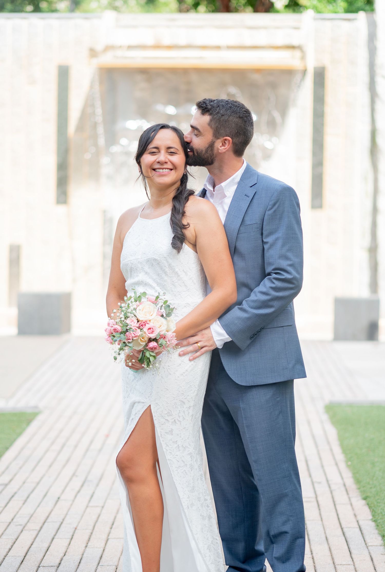 Beautiful couple after their elopement wedding in Charlotte NC. Bride wearing simple white dress while groom wears gorgeous blue suit.