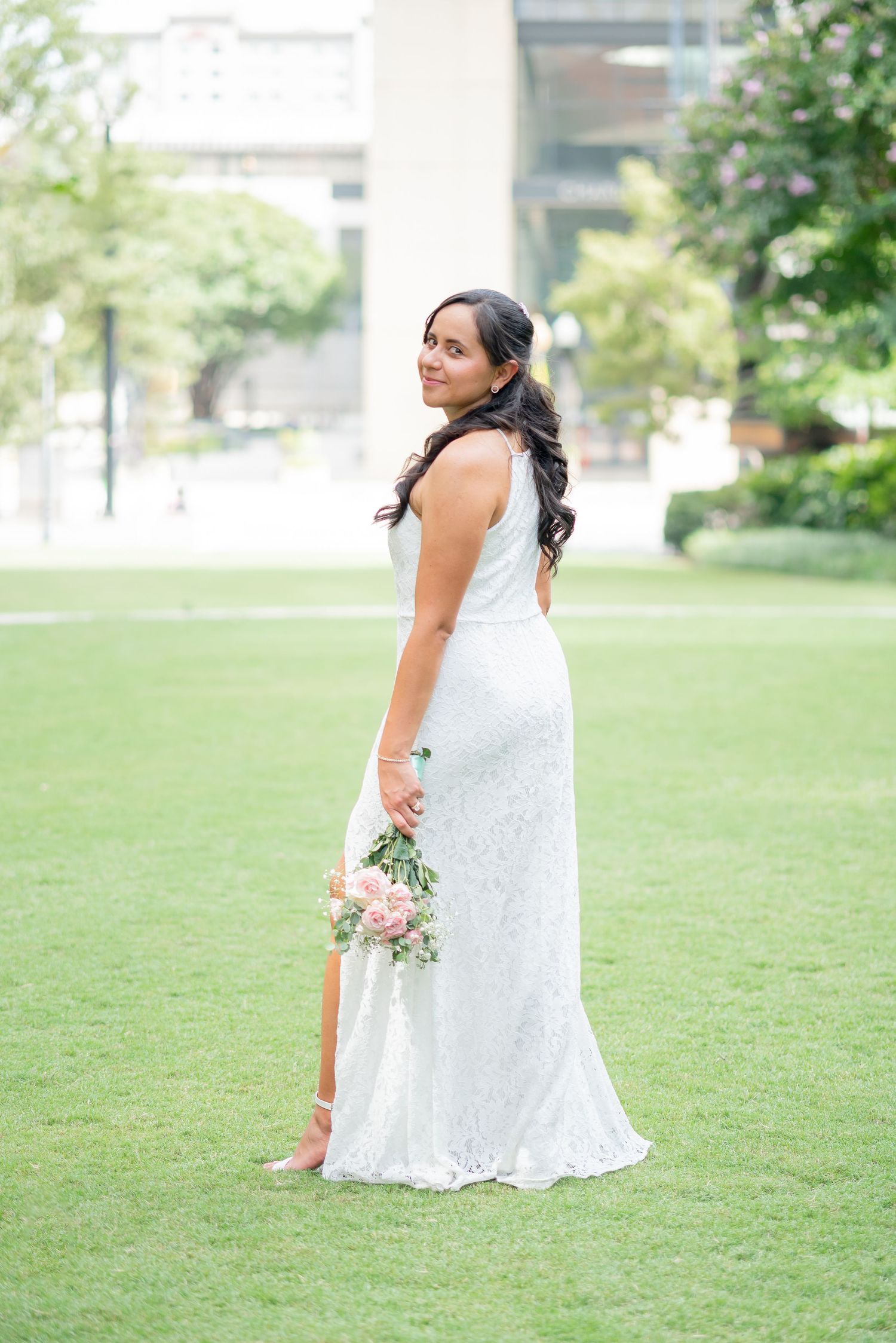 Beautiful couple after their elopement wedding in Charlotte NC. Bride wearing simple white dress while groom wears gorgeous blue suit.