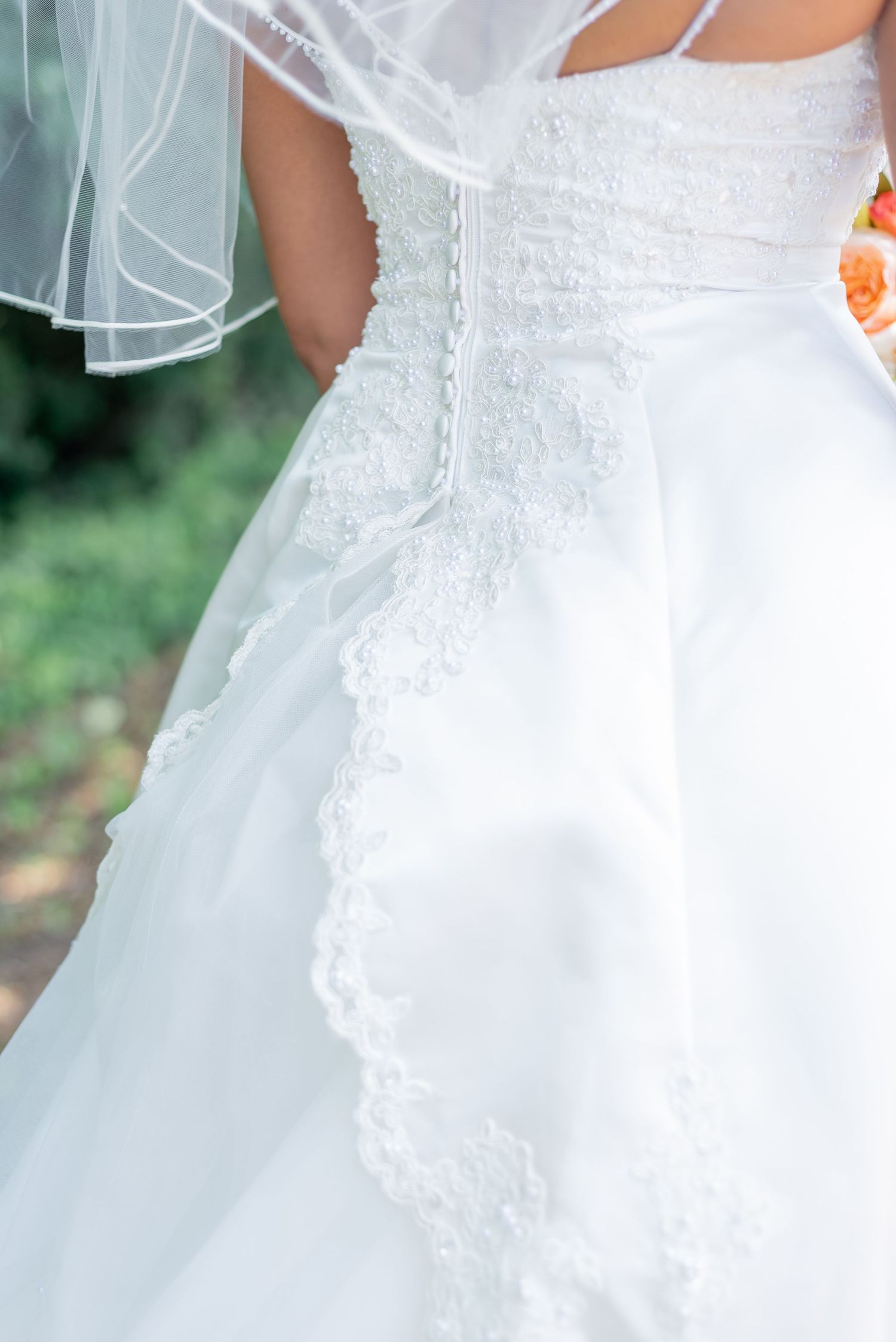 Details of a brides dress before her elopement wedding ceremony.