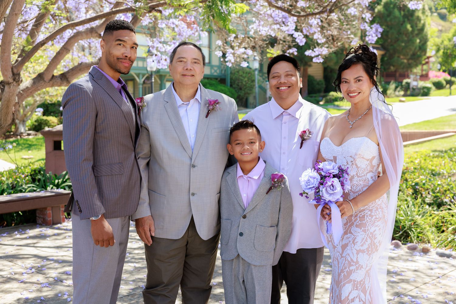 Bride and groom posing with family during Balboa Park wedding San Diego