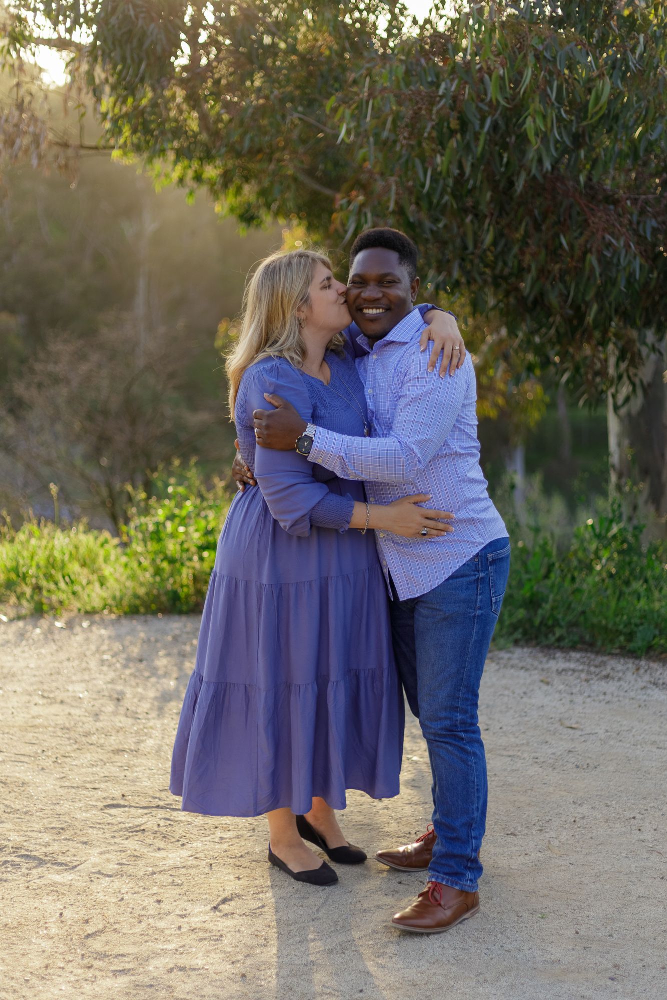 Black couple kissing each other at Balboa Park Cactus Garden