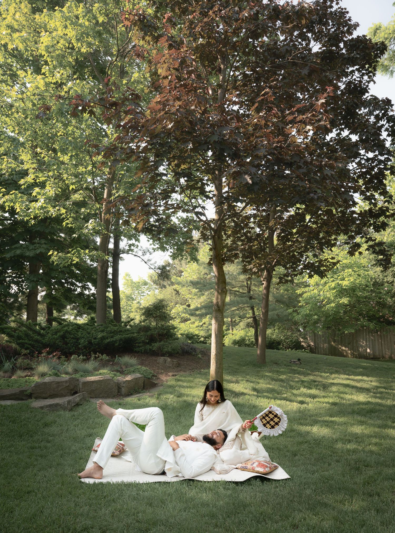 This image shows a couple at their traditional Indian photoshoot in the park.