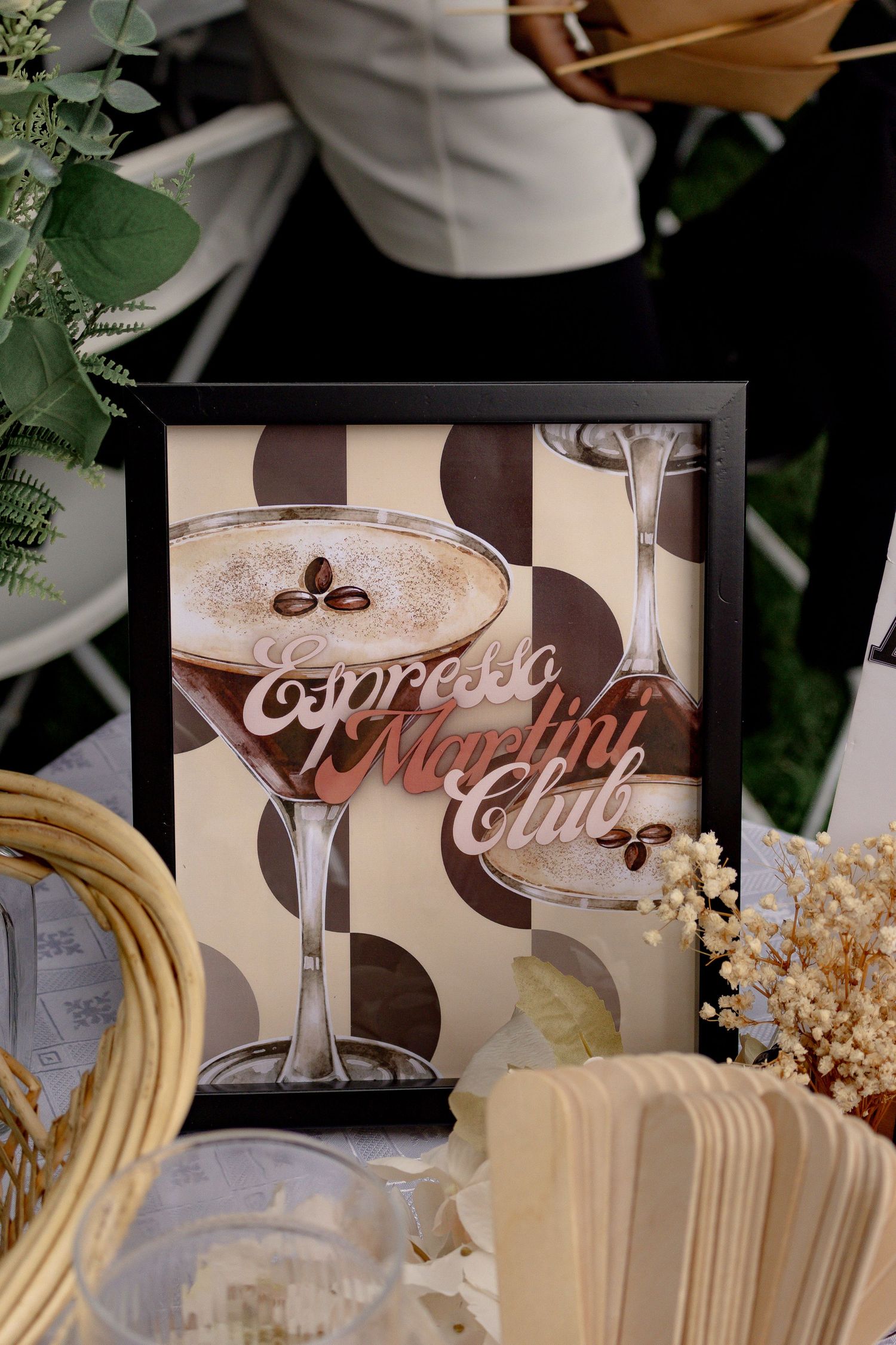 This image shows an 'espresso martini club' sign part of the event decor.