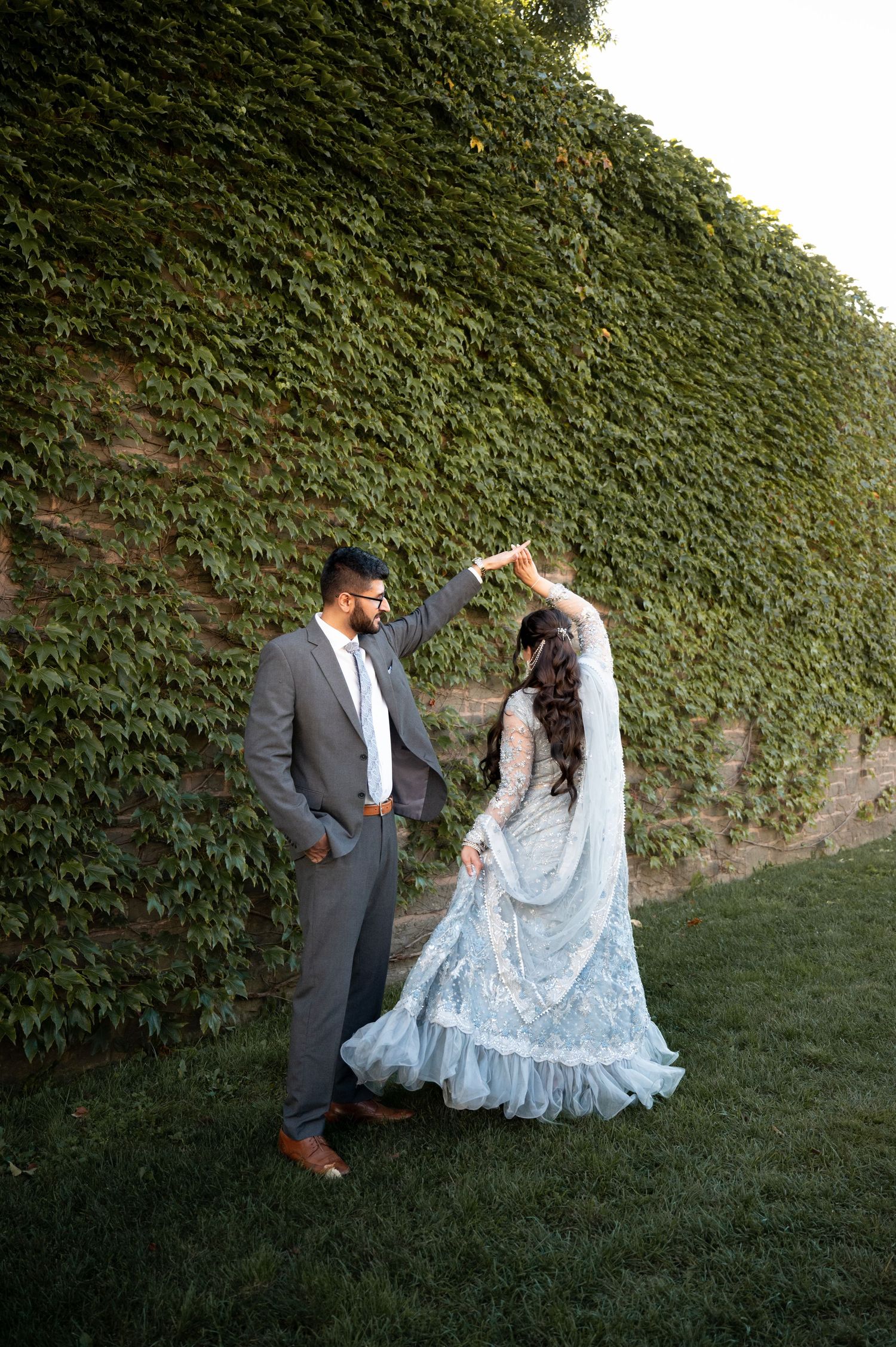 This image shows a couple at their engagement photoshoot in a park.