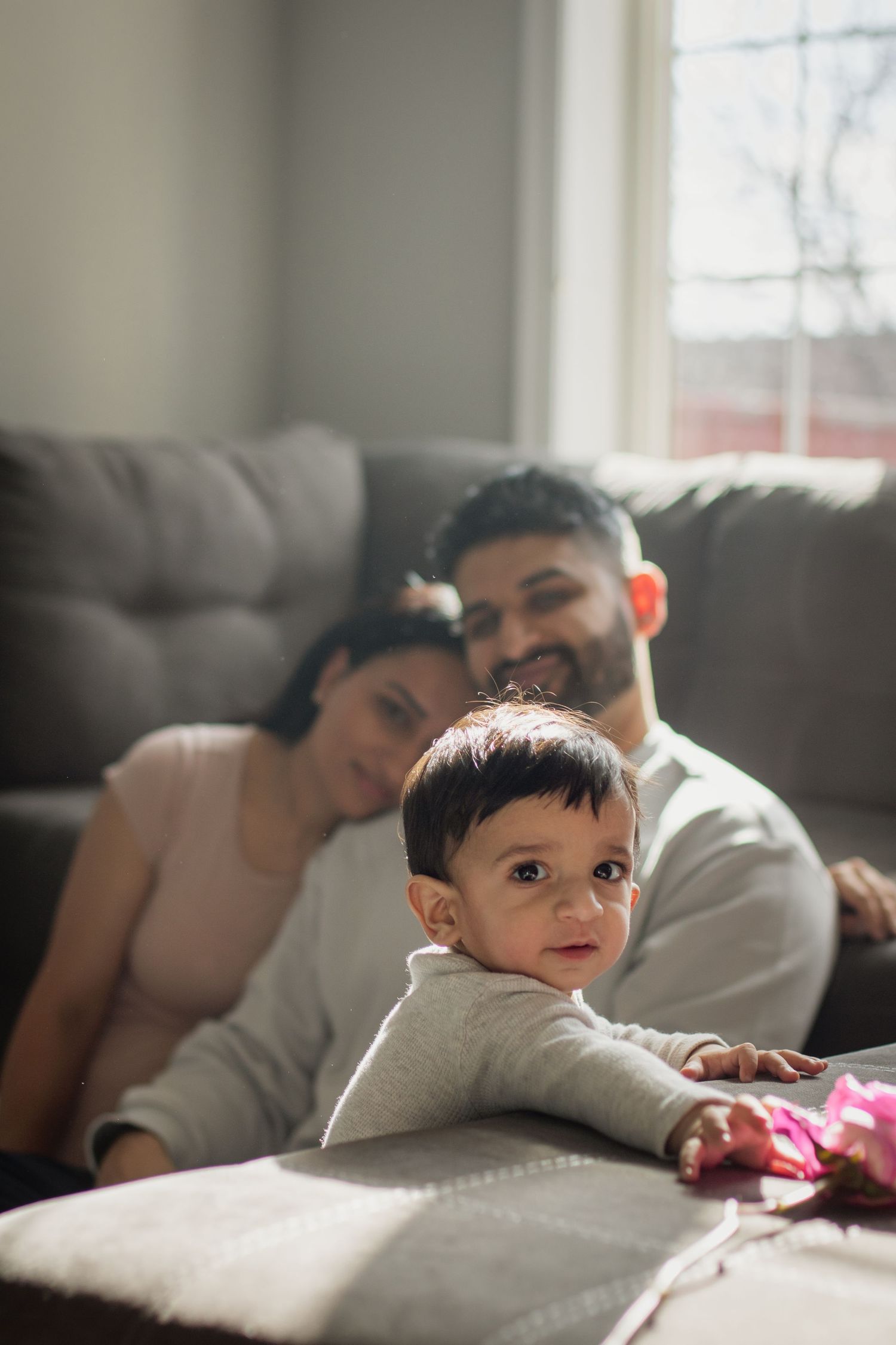 This image shows parents onlooking their toddler.