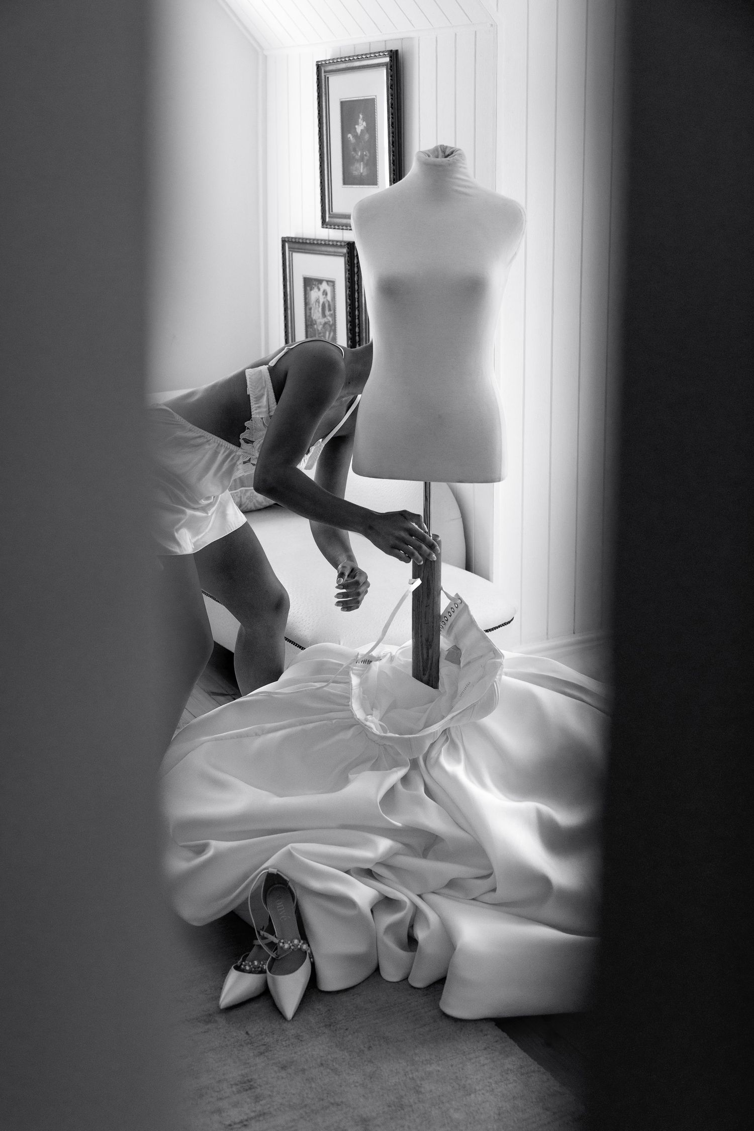 Black and white artistic photos of a wedding dress being fitted and styled on a dress form mannequin.