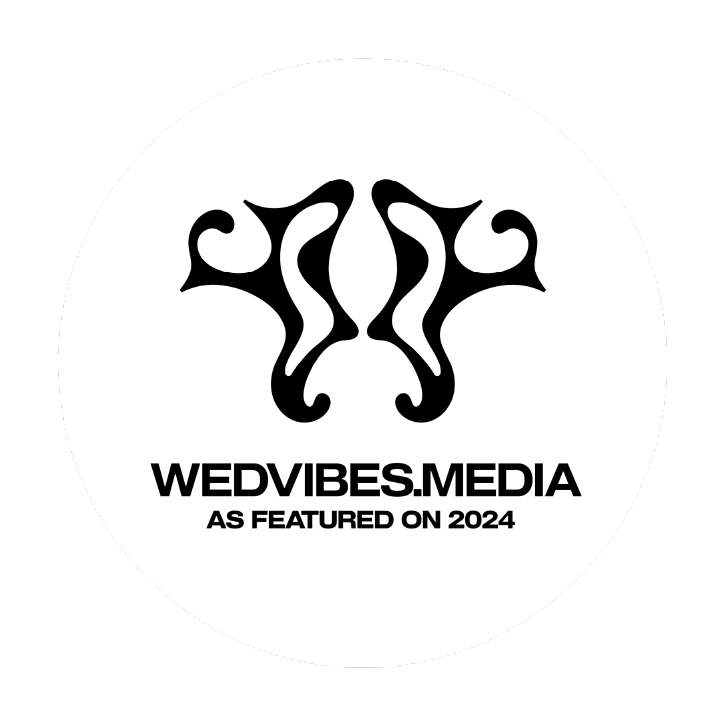 WedVibes Media black logo design with symmetrical decorative elements.