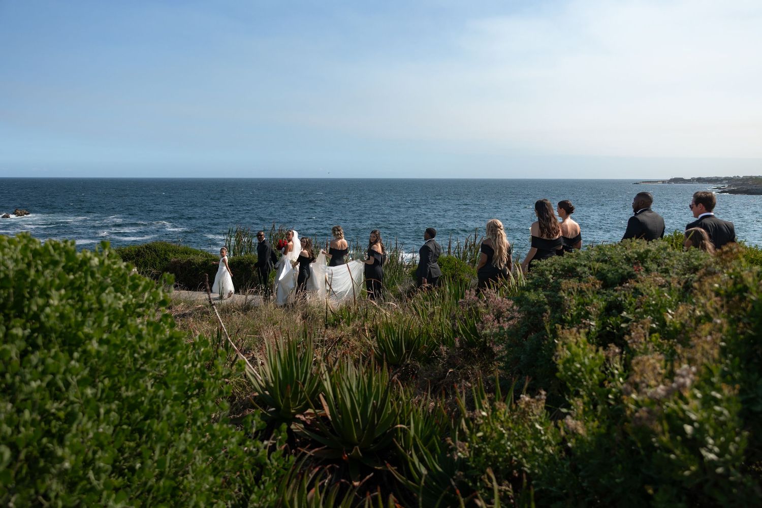 Scenic coastal landscape with rugged cliffs and crashing waves along the Pacific Ocean shore.
