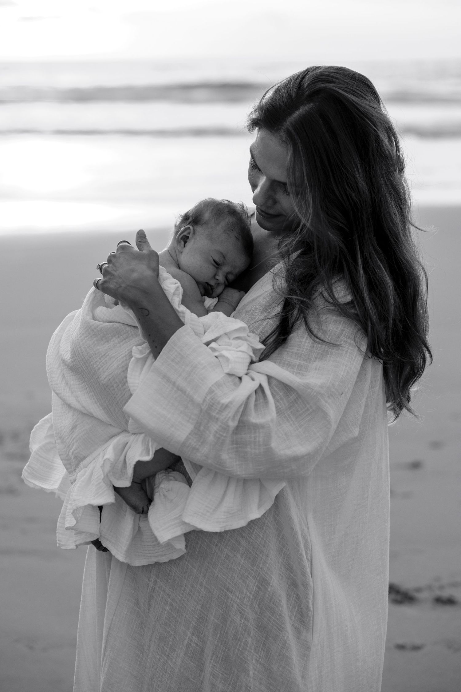 Black and white beach photos showing movement and flowing white fabric in the wind.