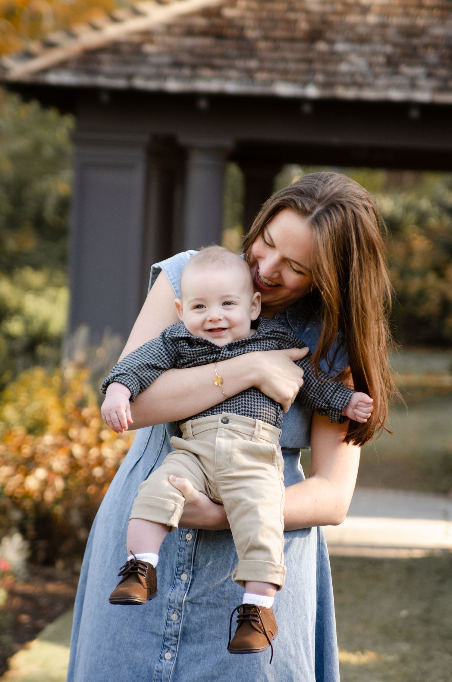 Parent interacting with baby during an outdoor lifestyle photography session in Charlotte, NC.
