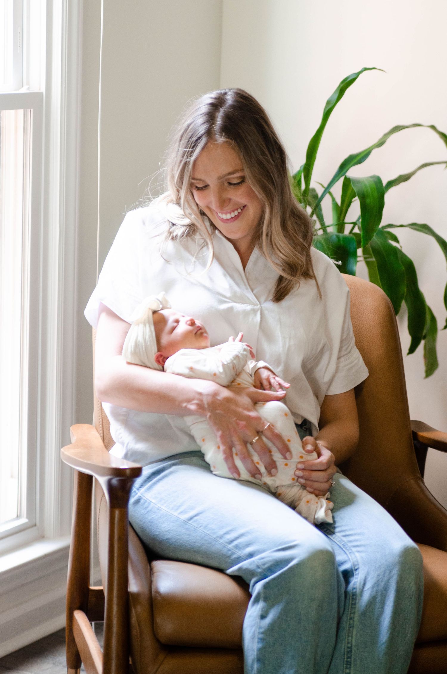 Parent holding and bonding with a baby during an in-home lifestyle photography session in Charlotte, NC.