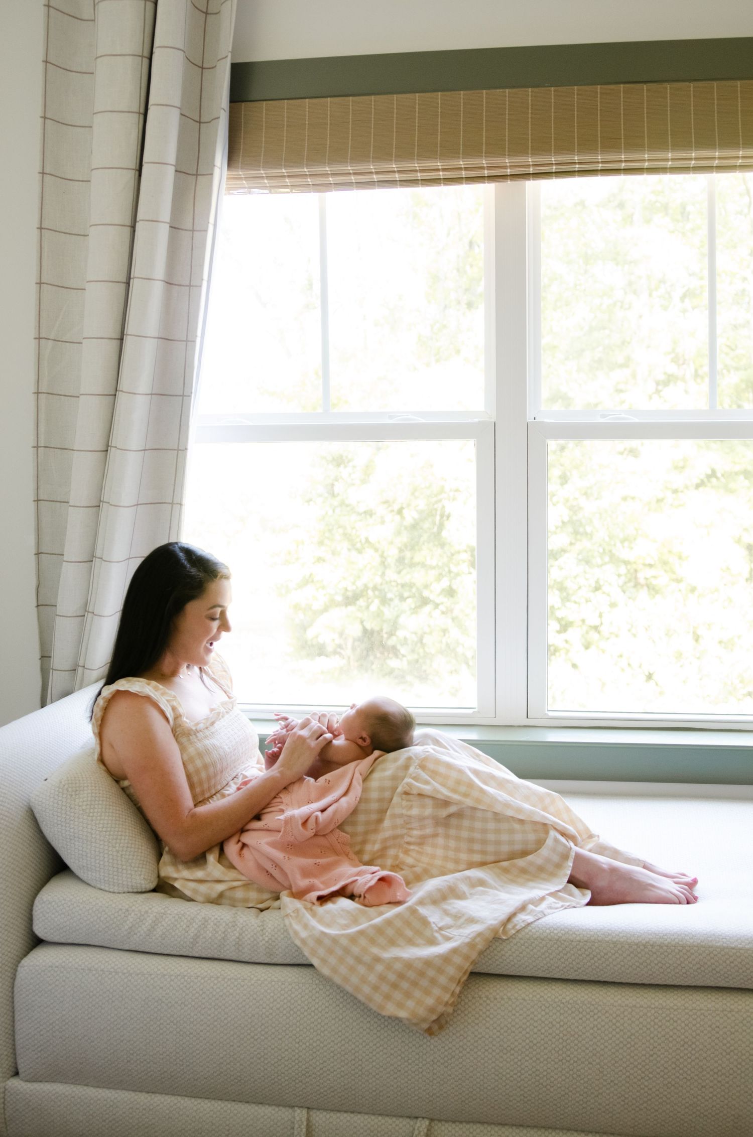 A series of four photos showing a relaxing moment on a window seat cushion in soft natural light.
