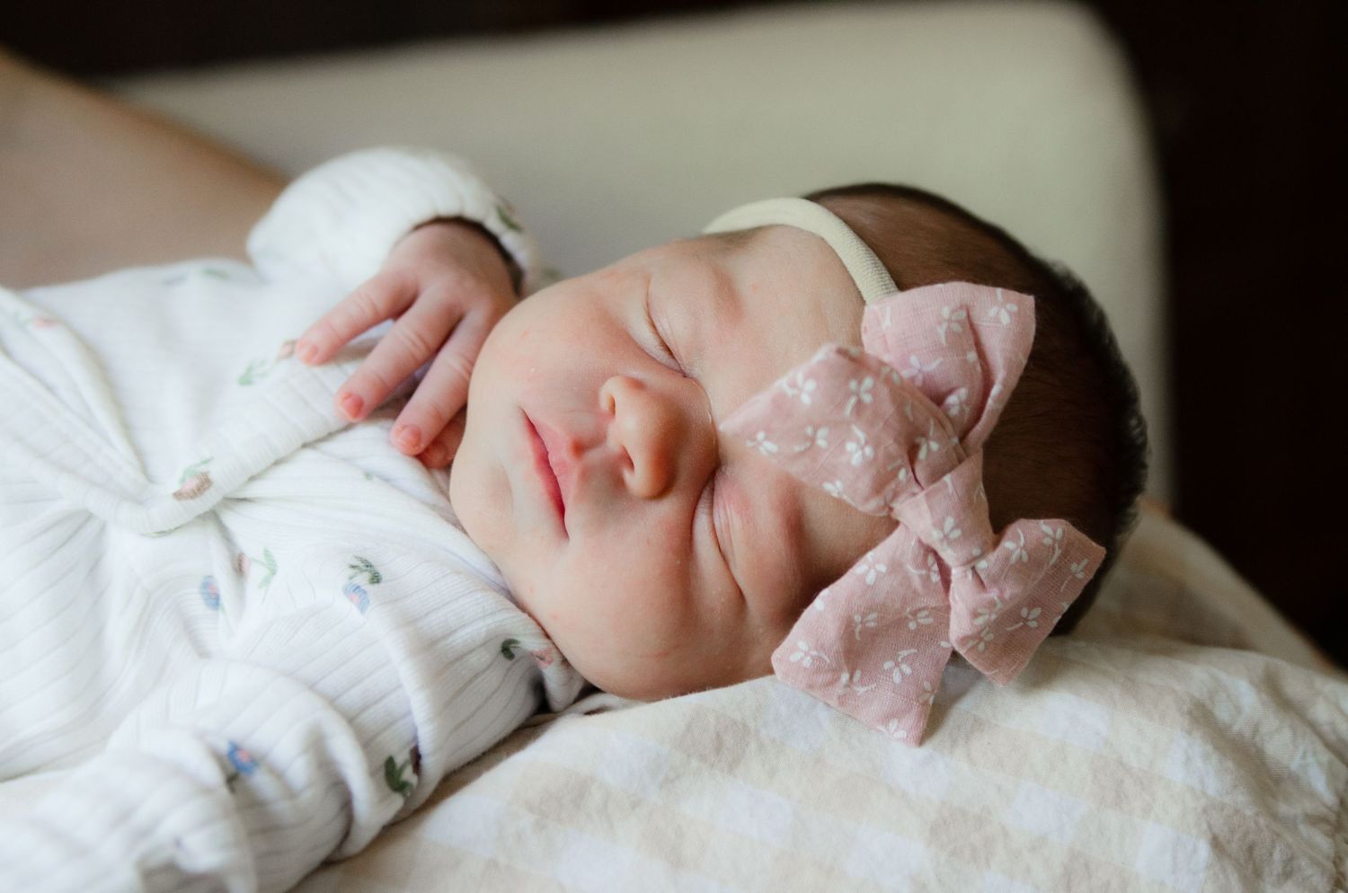 Sleeping newborn resting peacefully during a lifestyle newborn photography session in Charlotte, NC.