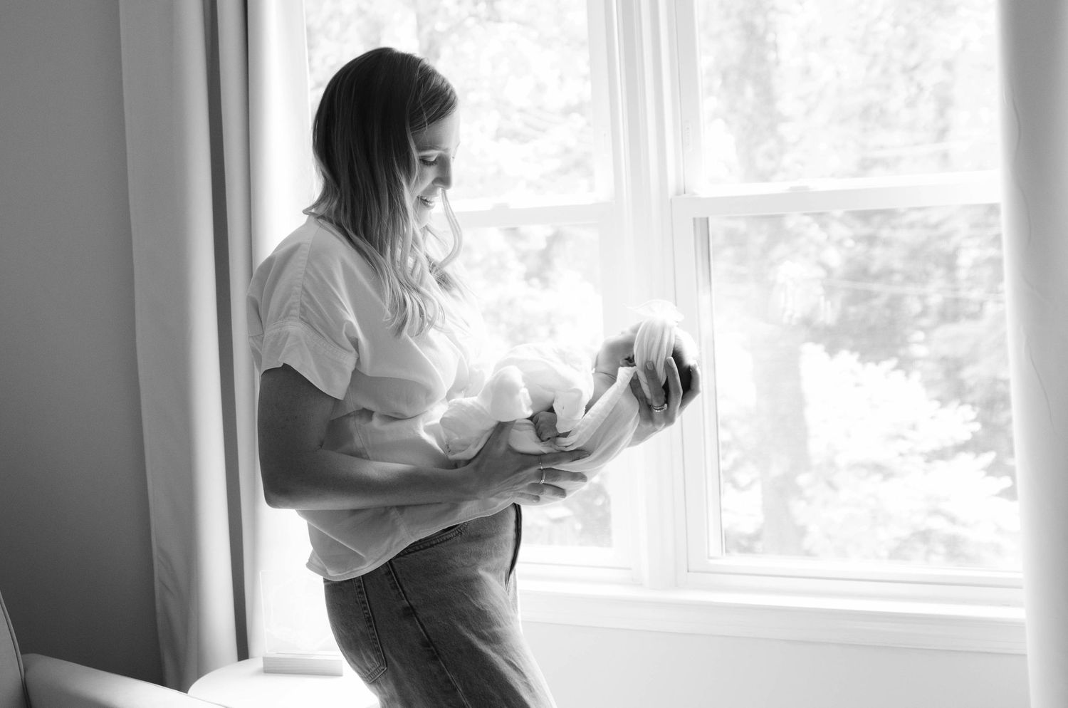 In-home family photography session in Charlotte, NC captured near a bright window.