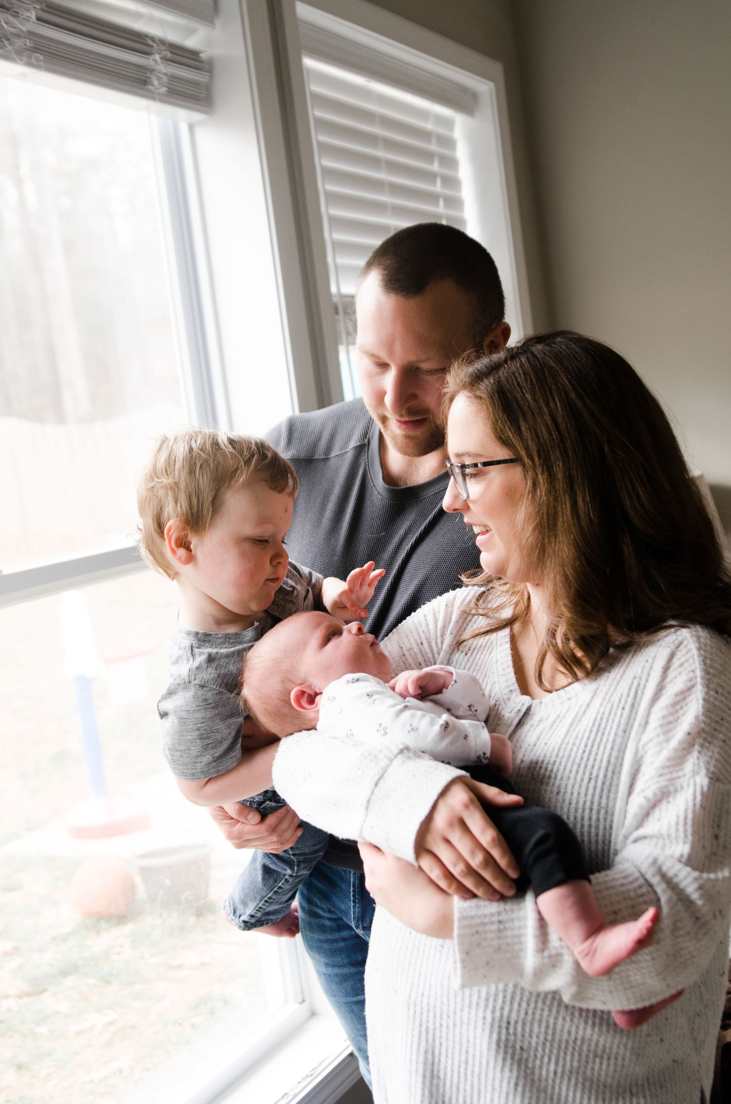 In-home family photography session in Charlotte, NC captured in natural window light.