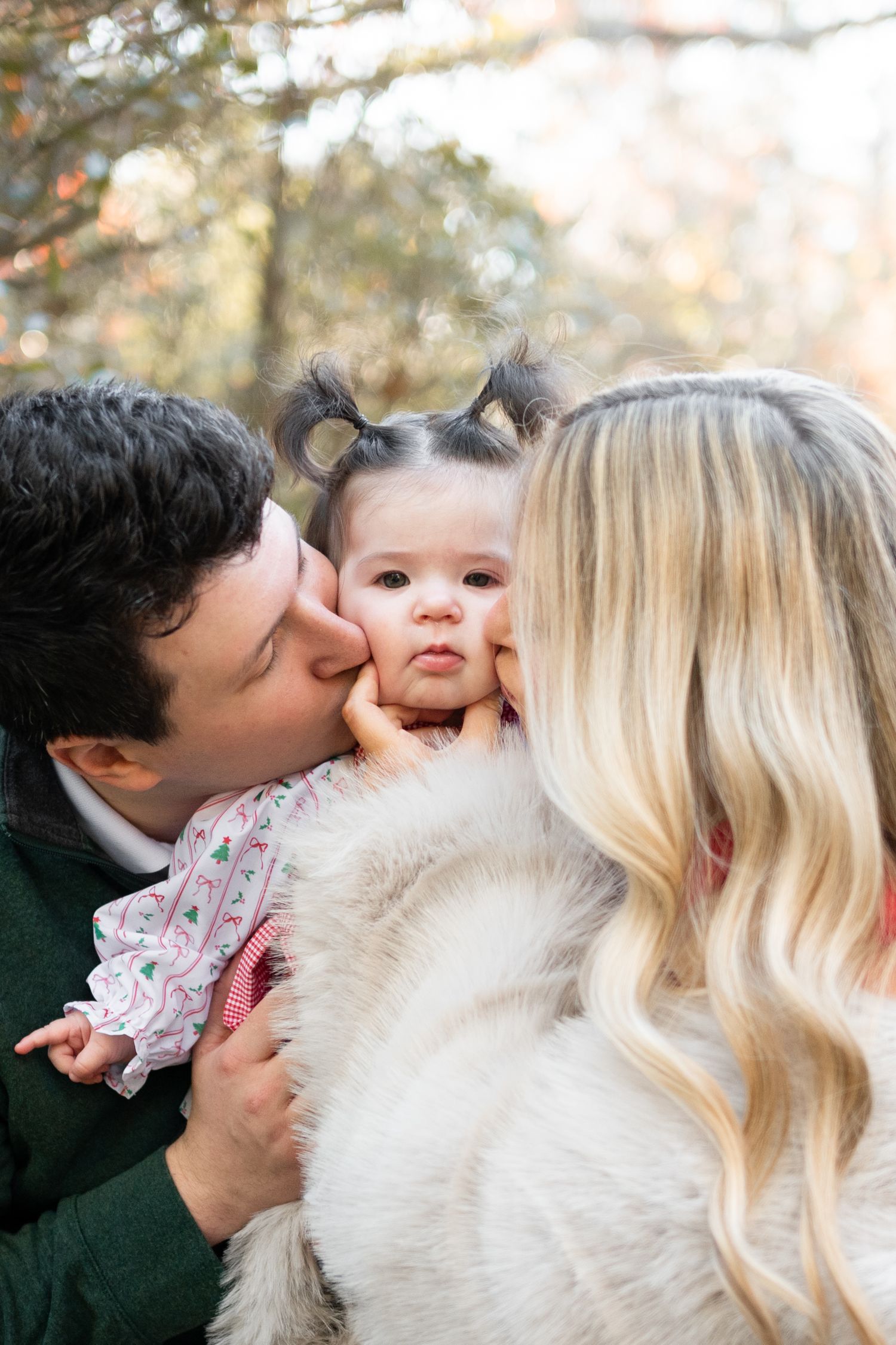 Family sharing kisses and embraces during an outdoor fall photography session in Charlotte, NC.