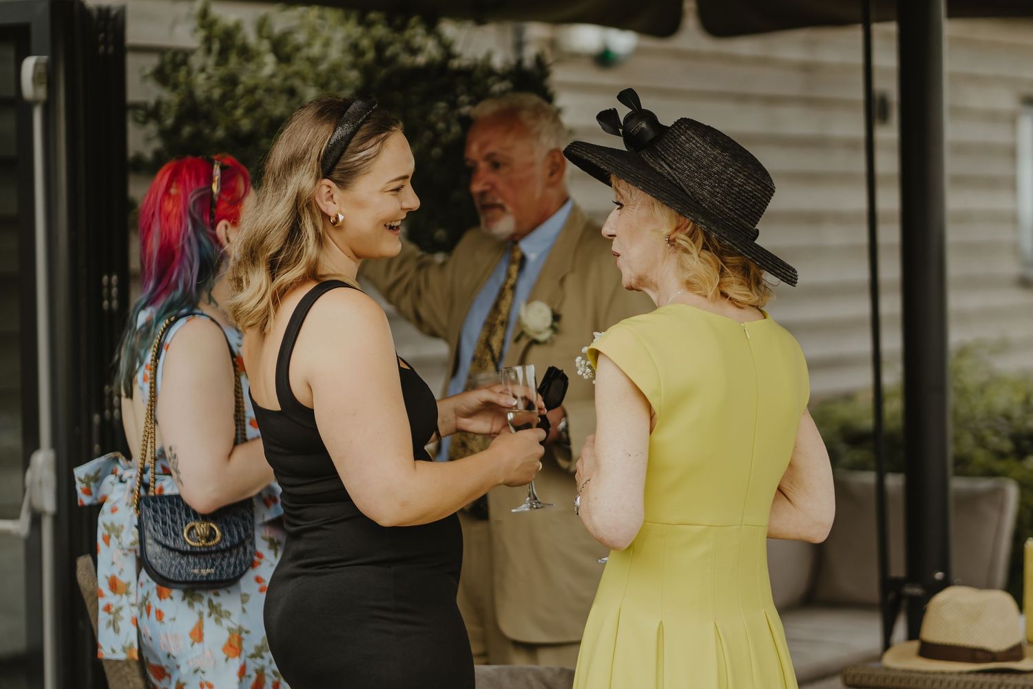 Wedding guests dance and celebrate during outdoor reception party.