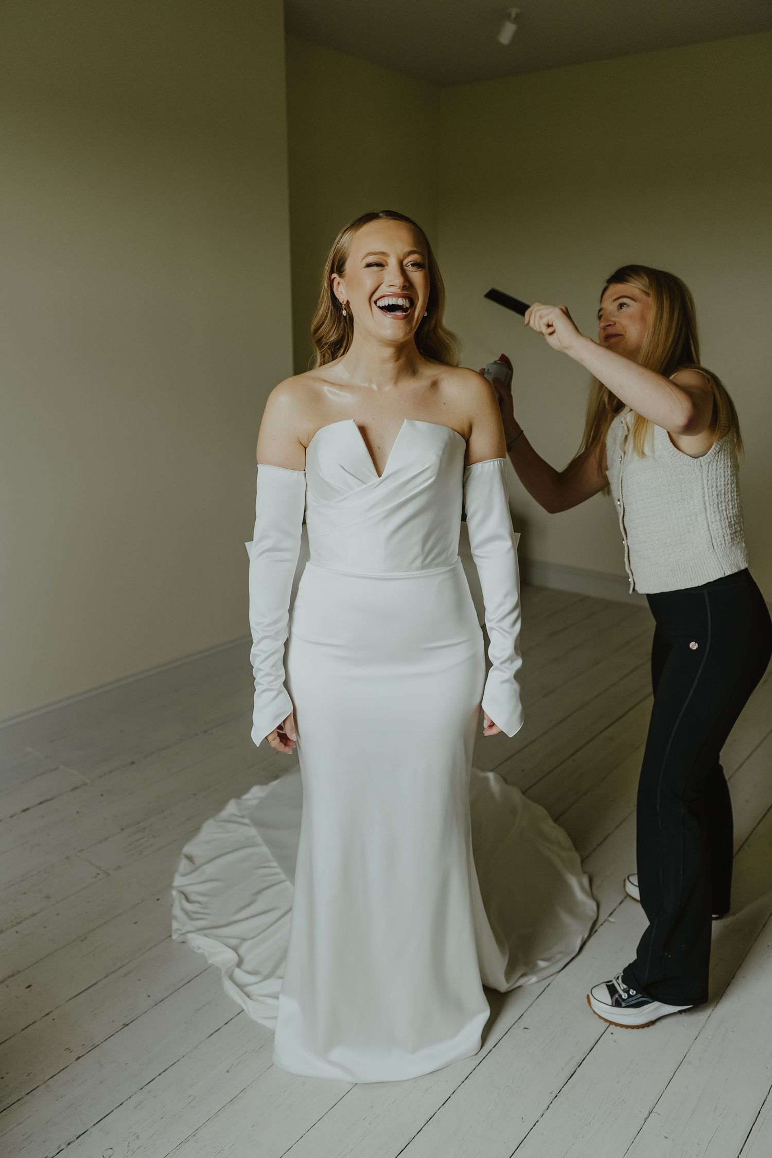 Wedding preparation scene showing final touches being made to the bridal look.