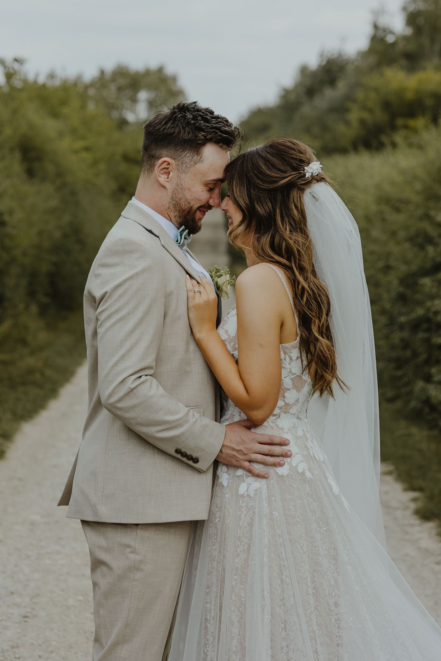 An intimate moment between newlyweds sharing a laugh on their wedding day.