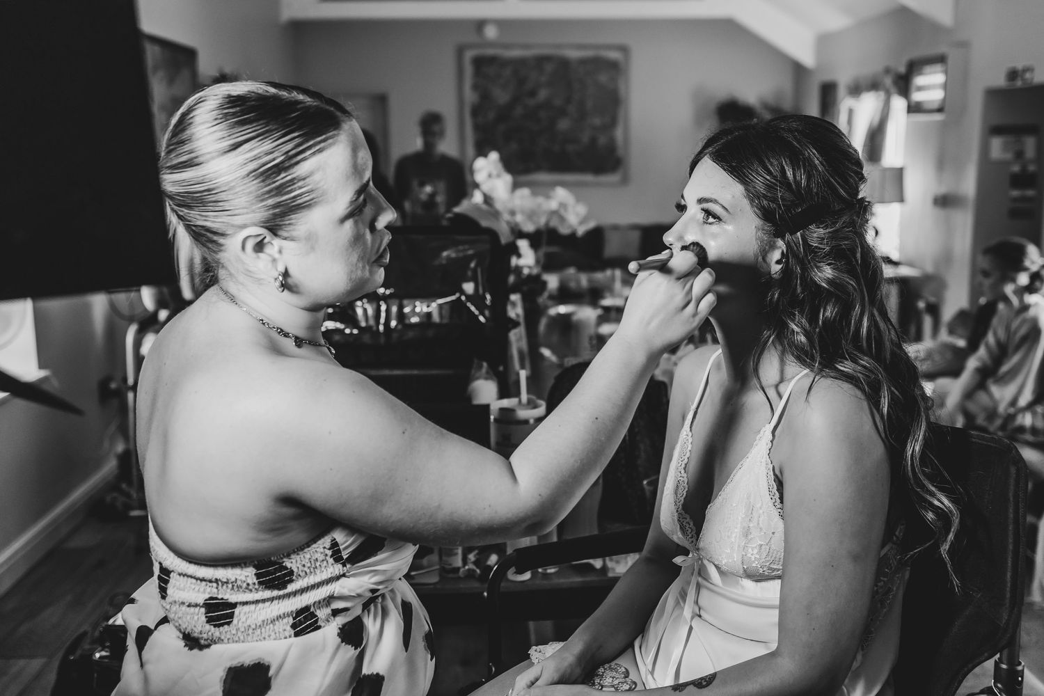 Black and white candid moments during wedding preparations.