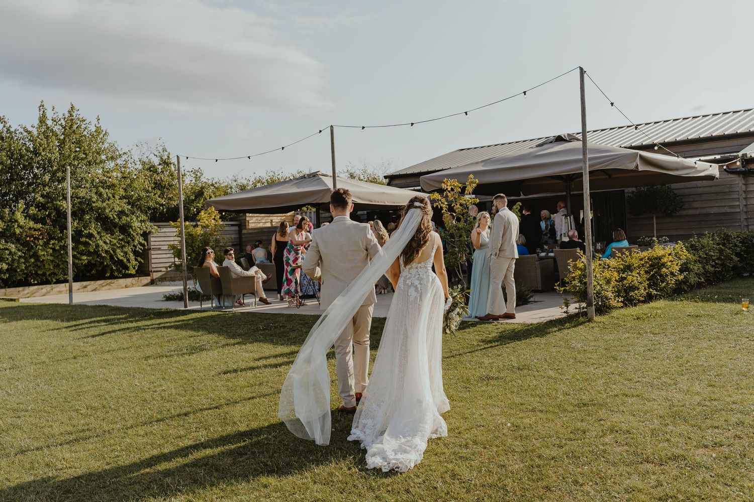 Wedding celebration at outdoor venue with string lights and rustic decor.