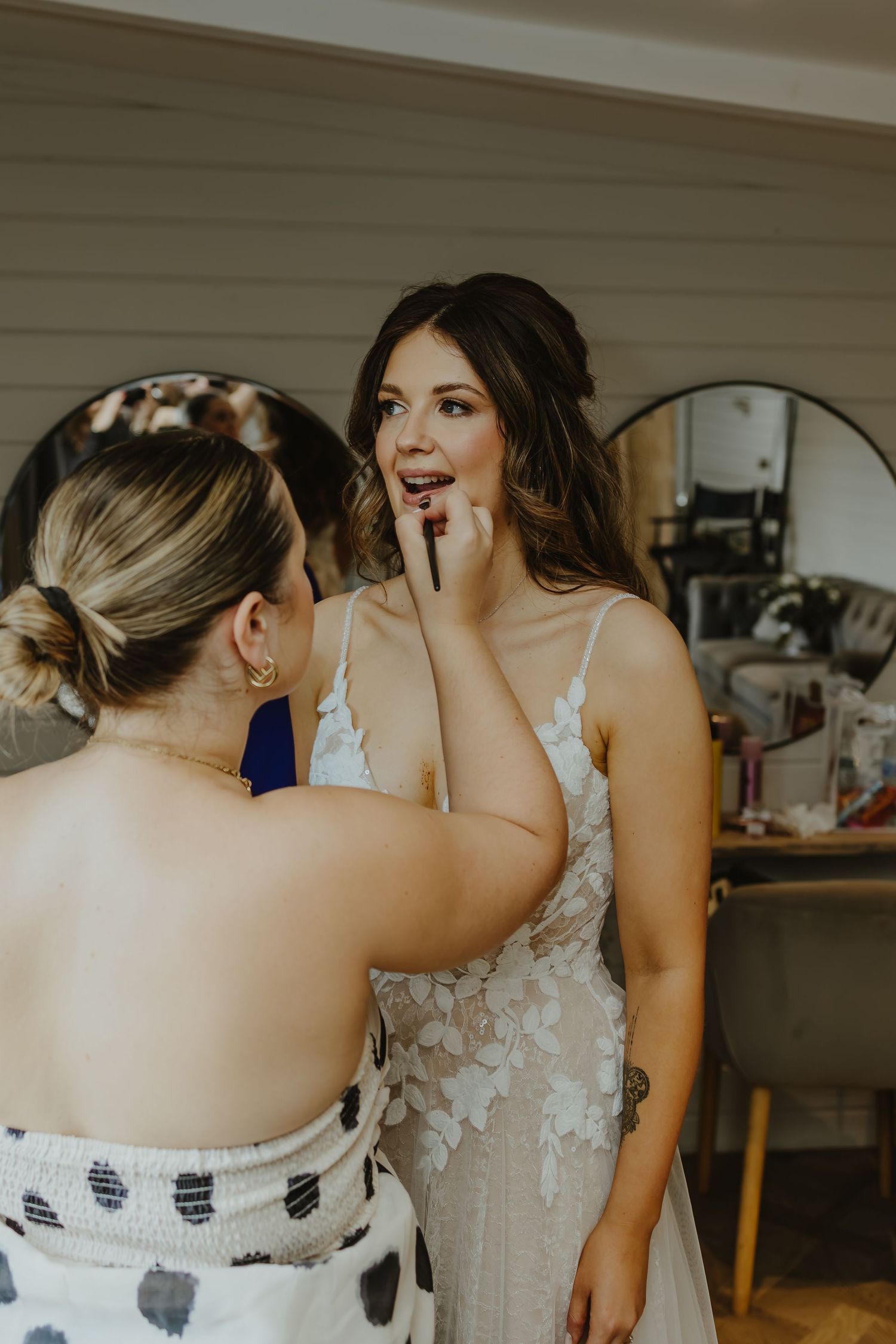 Wedding dress being adjusted and secured during preparation.