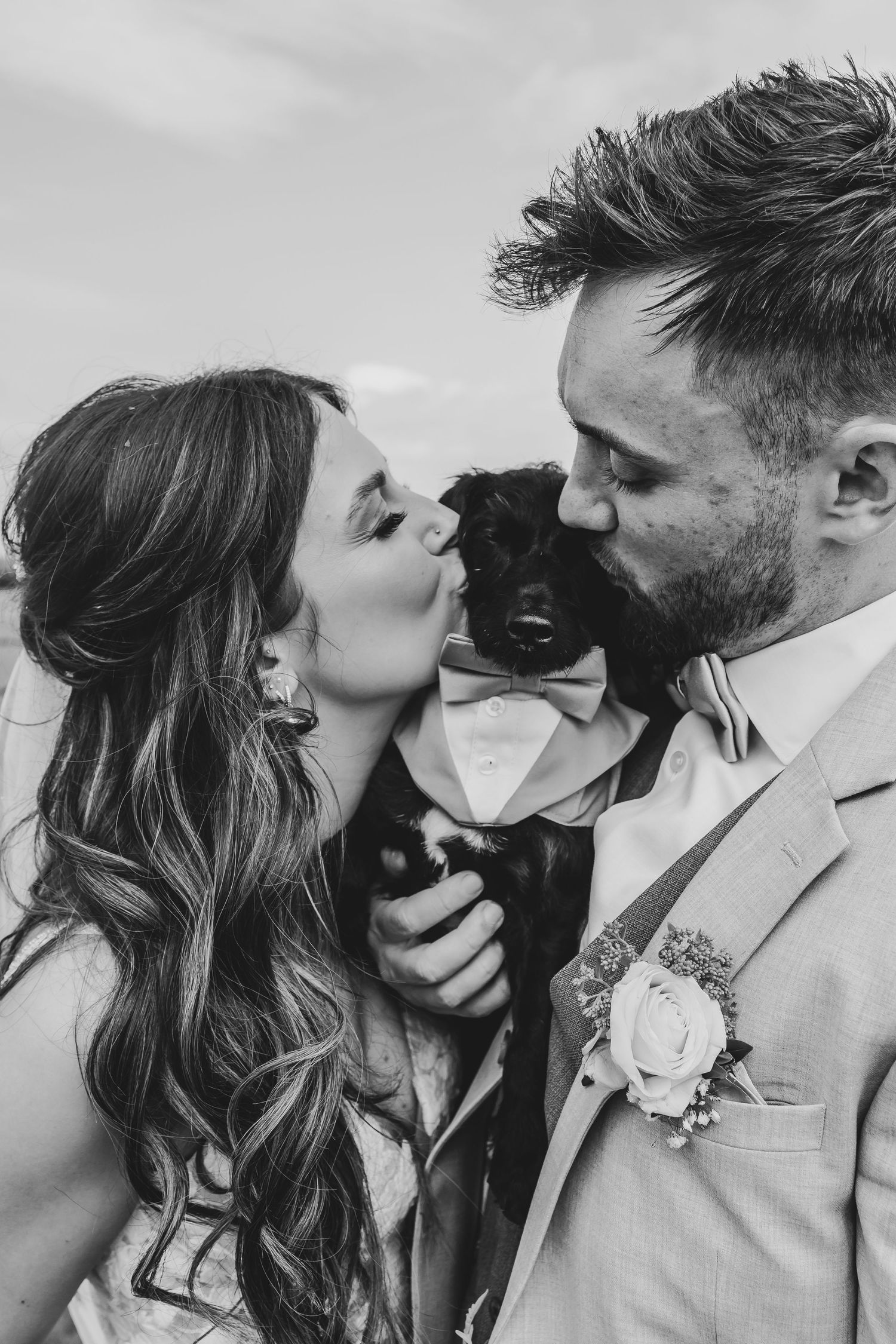 Intimate black and white wedding portraits showing romantic moments between newlyweds.