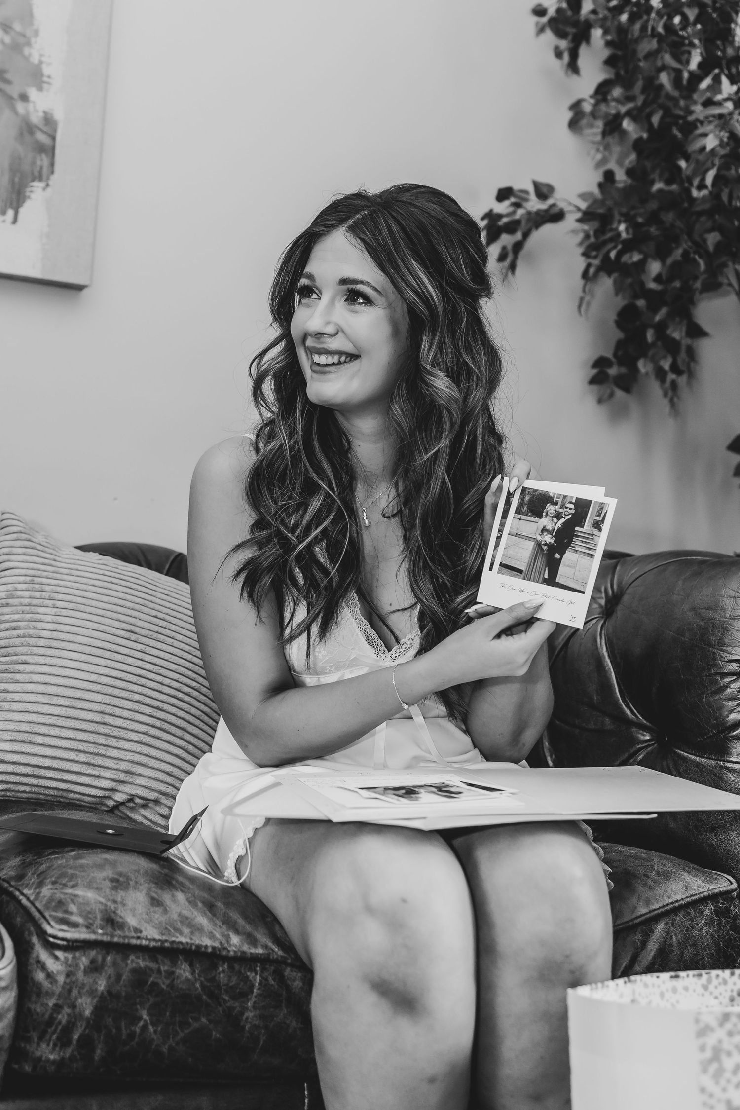 Person on couch looking at photos with excitement and joy.