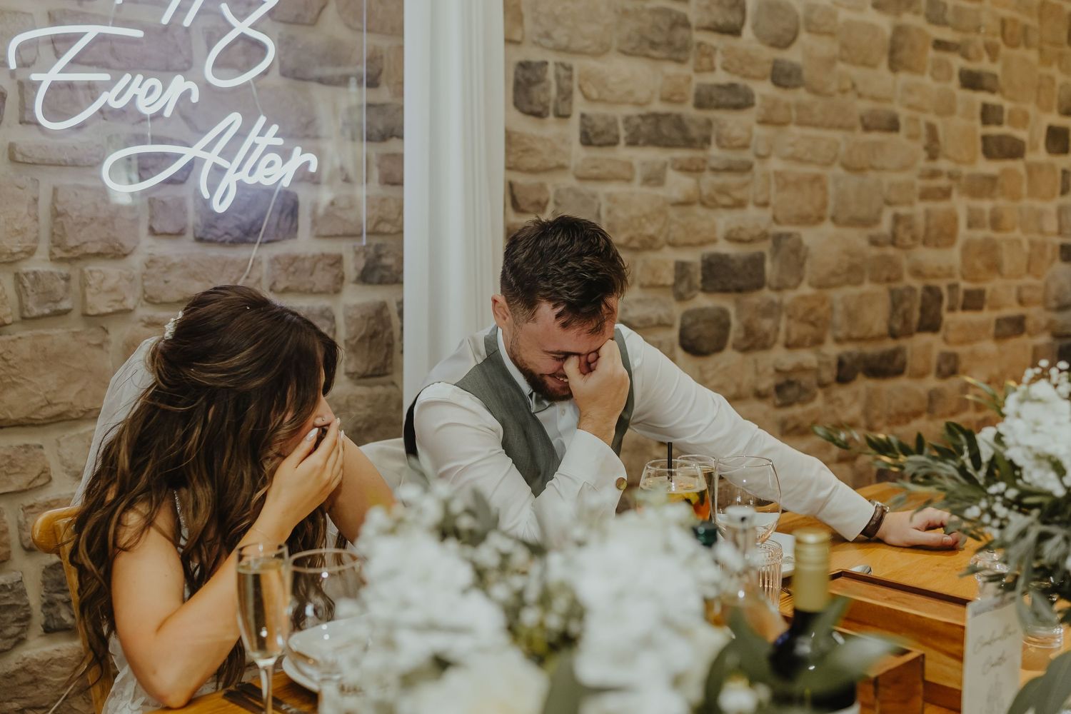 Rustic wedding venue interior with stone walls and decorative lighting.