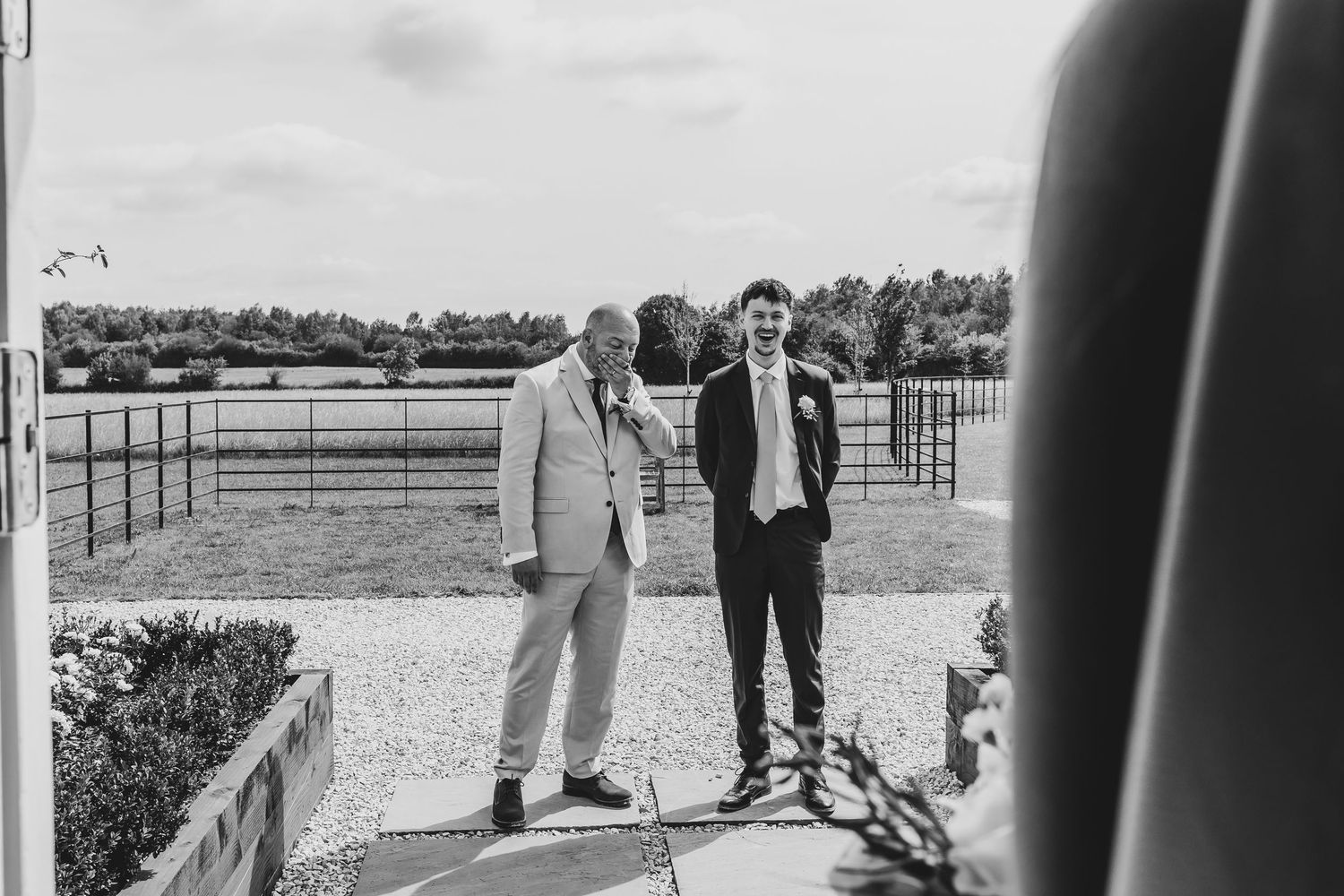 Wedding ceremony setup with guests gathered on a scenic outdoor property.