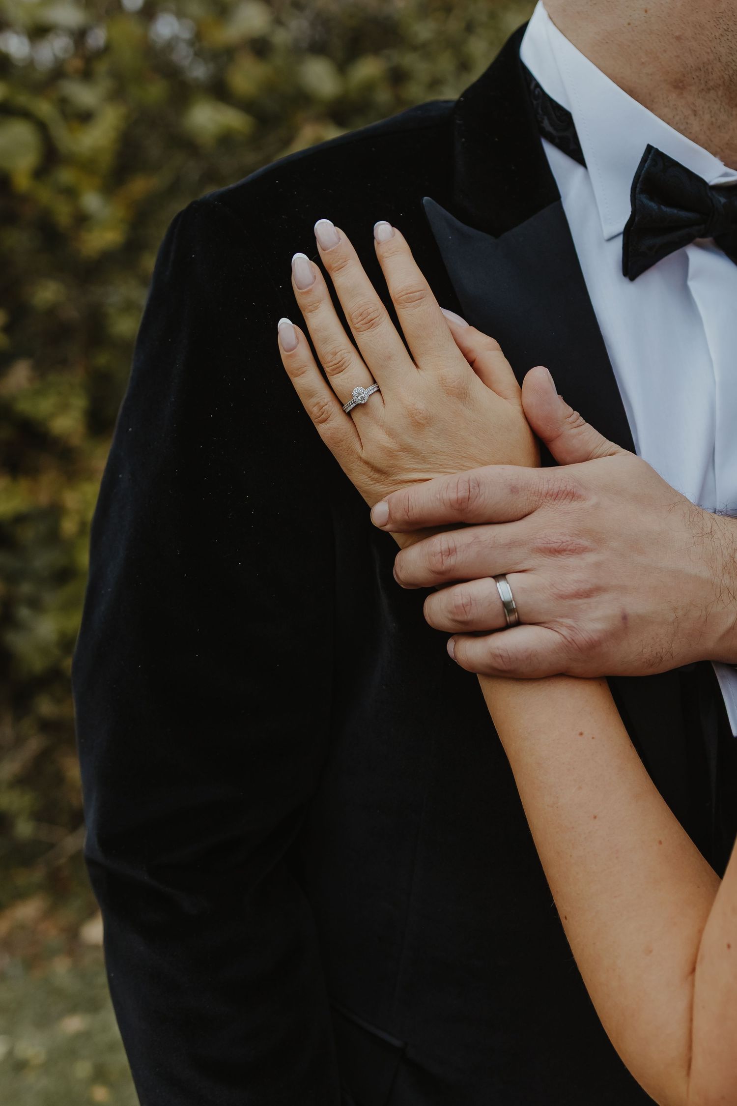 Close-up shots of hands showing wedding rings against a dark background.