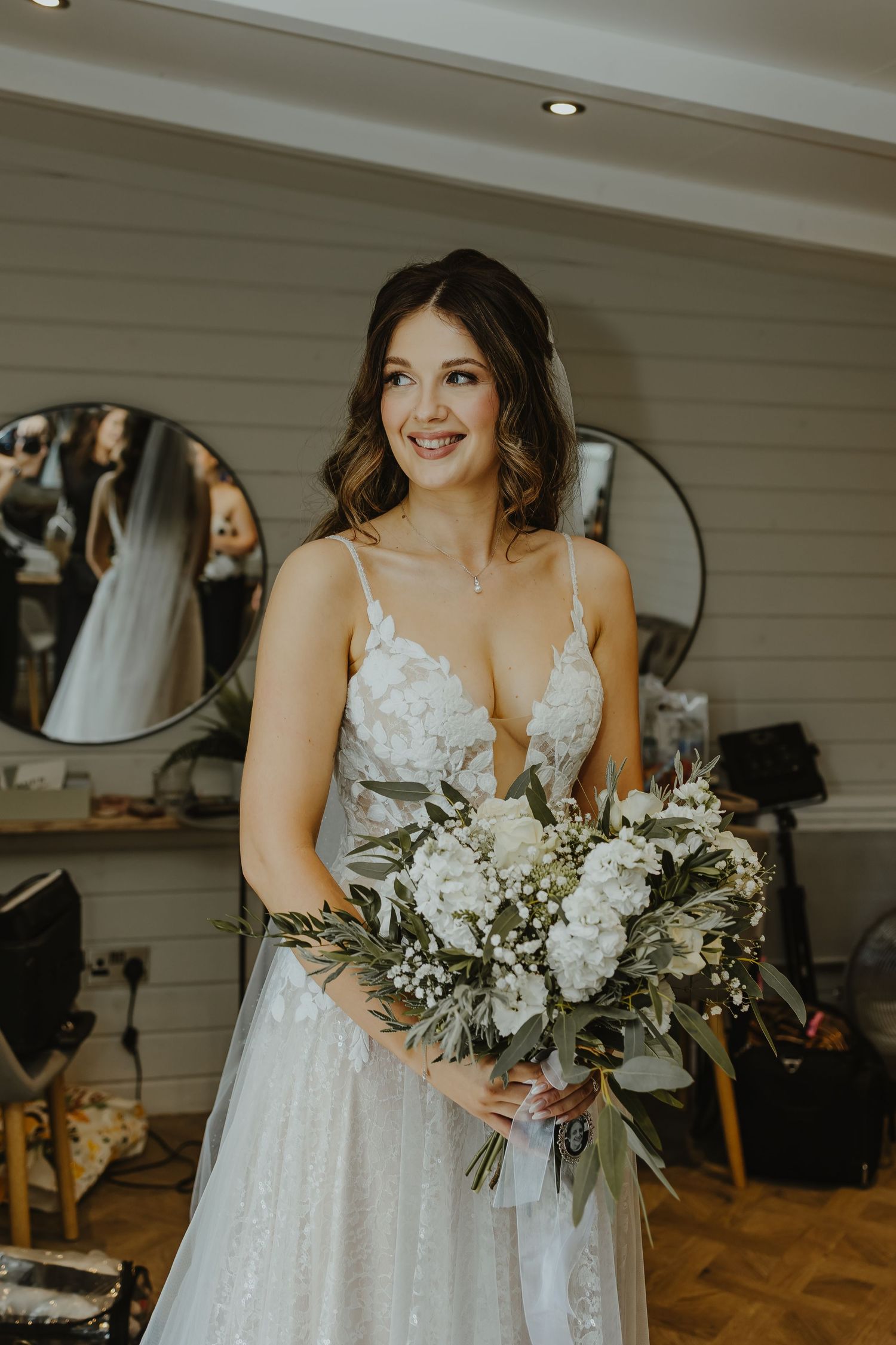 Close up of a beautiful white and green bridal bouquet with delicate floral details.