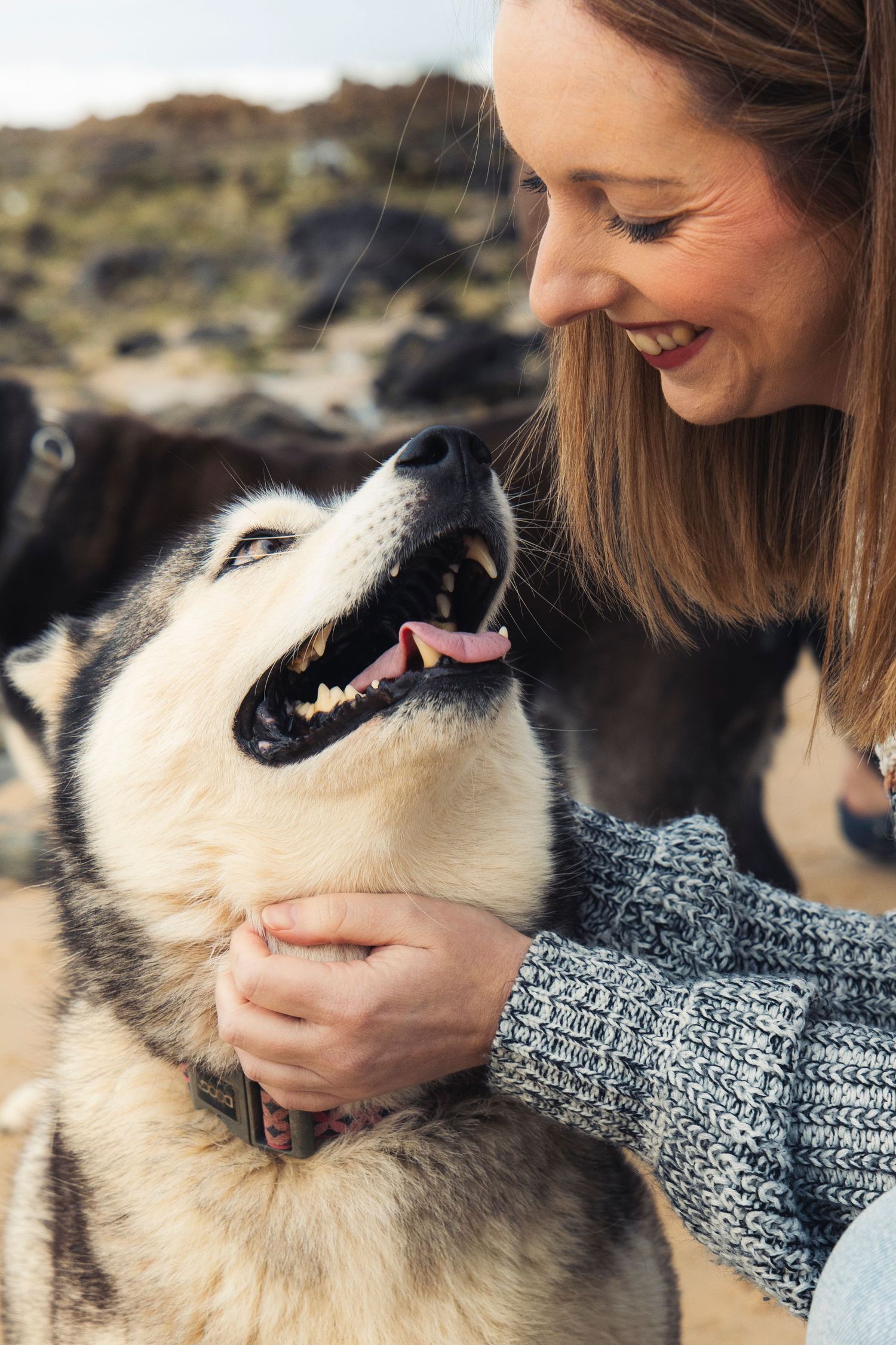 A woman and her dog at the beach