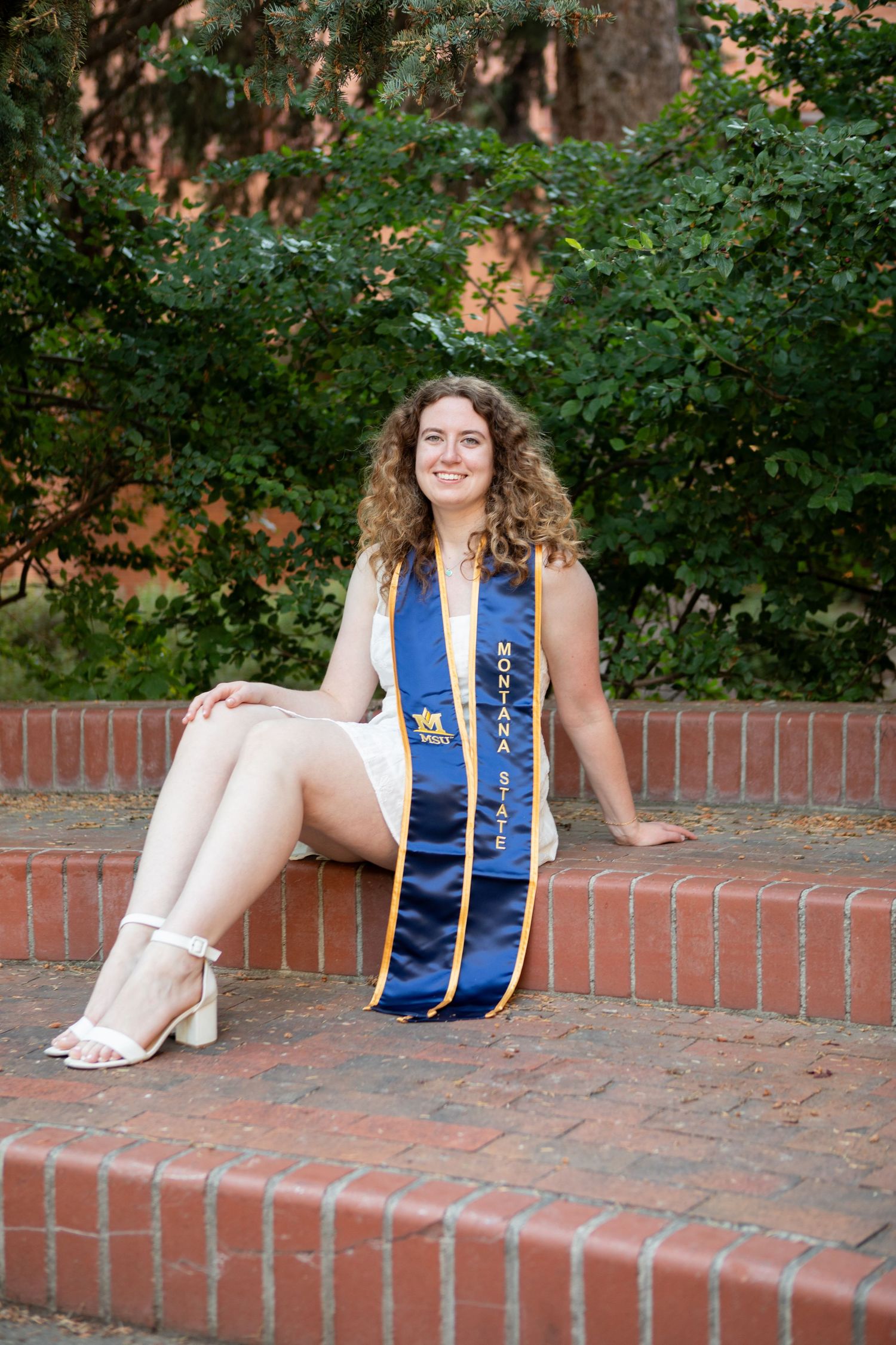 Montana State University Grad sitting on campus in Bozeman, Montana.