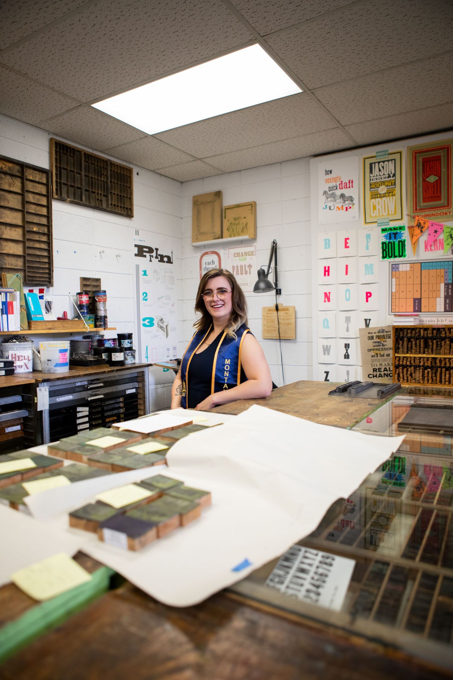 A Montana State University Grad posing in the print making room in Haynes Hall.