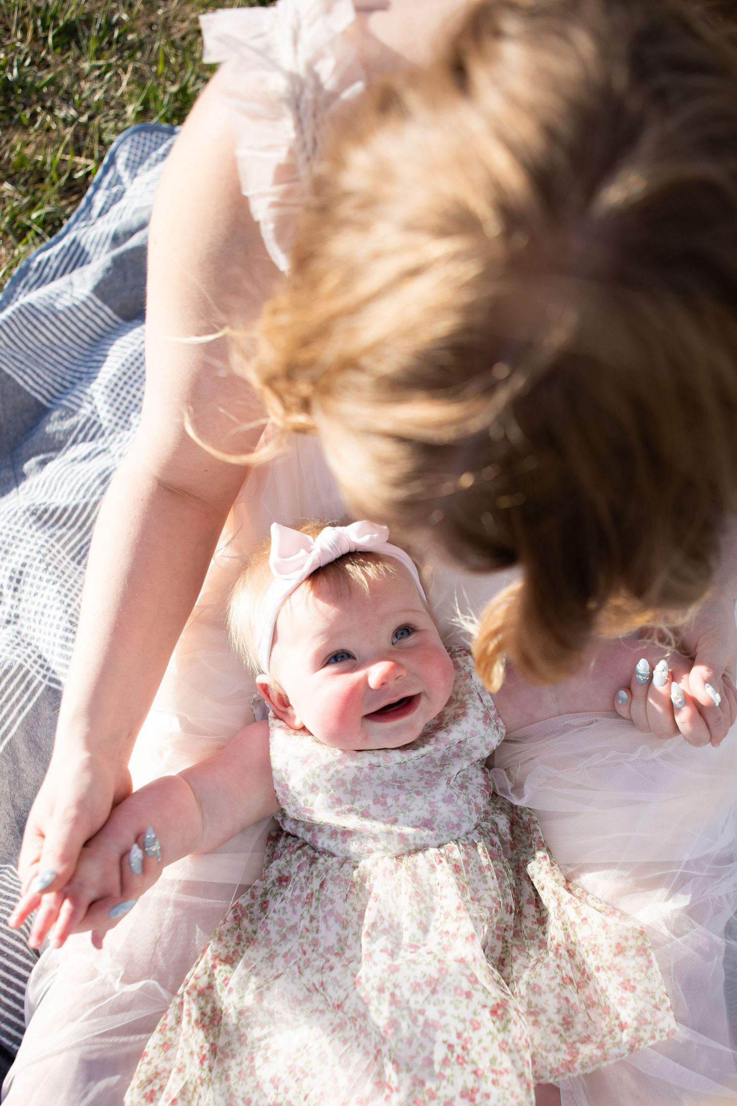 A Bozeman baby smiles up at her mom during a Mother's Day Session in Bozeman, Montana.