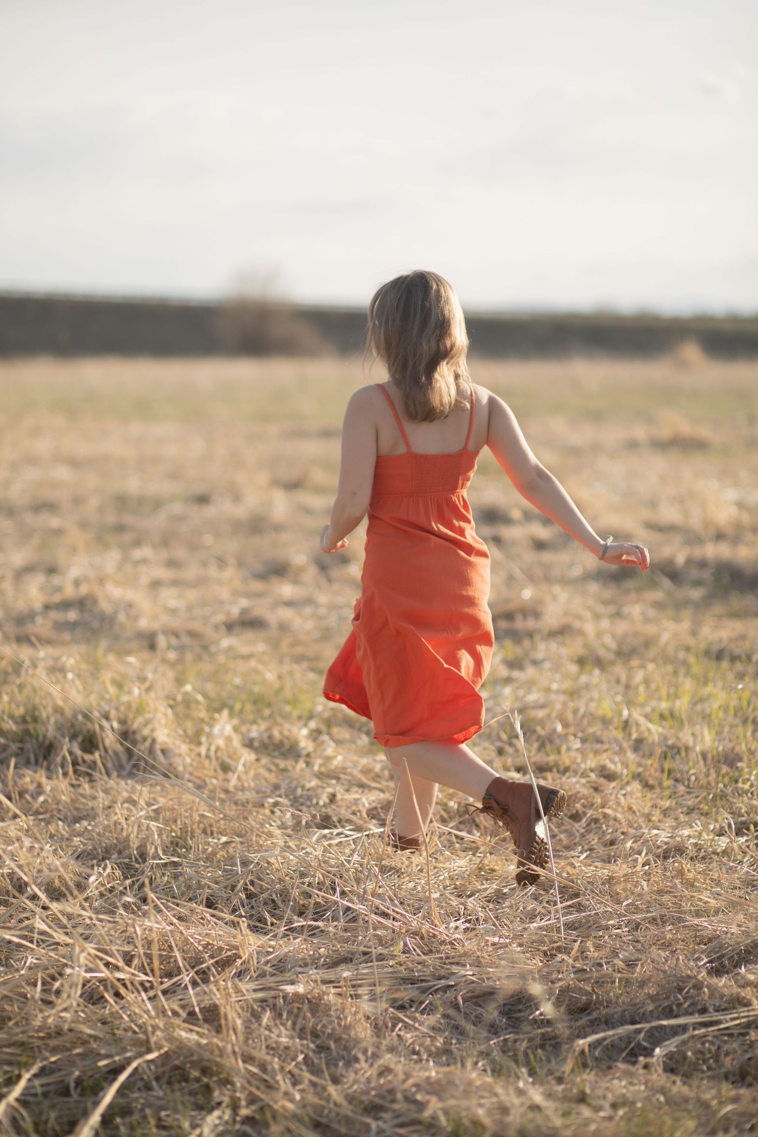 A Bozeman Senior running through a field in Bozeman.